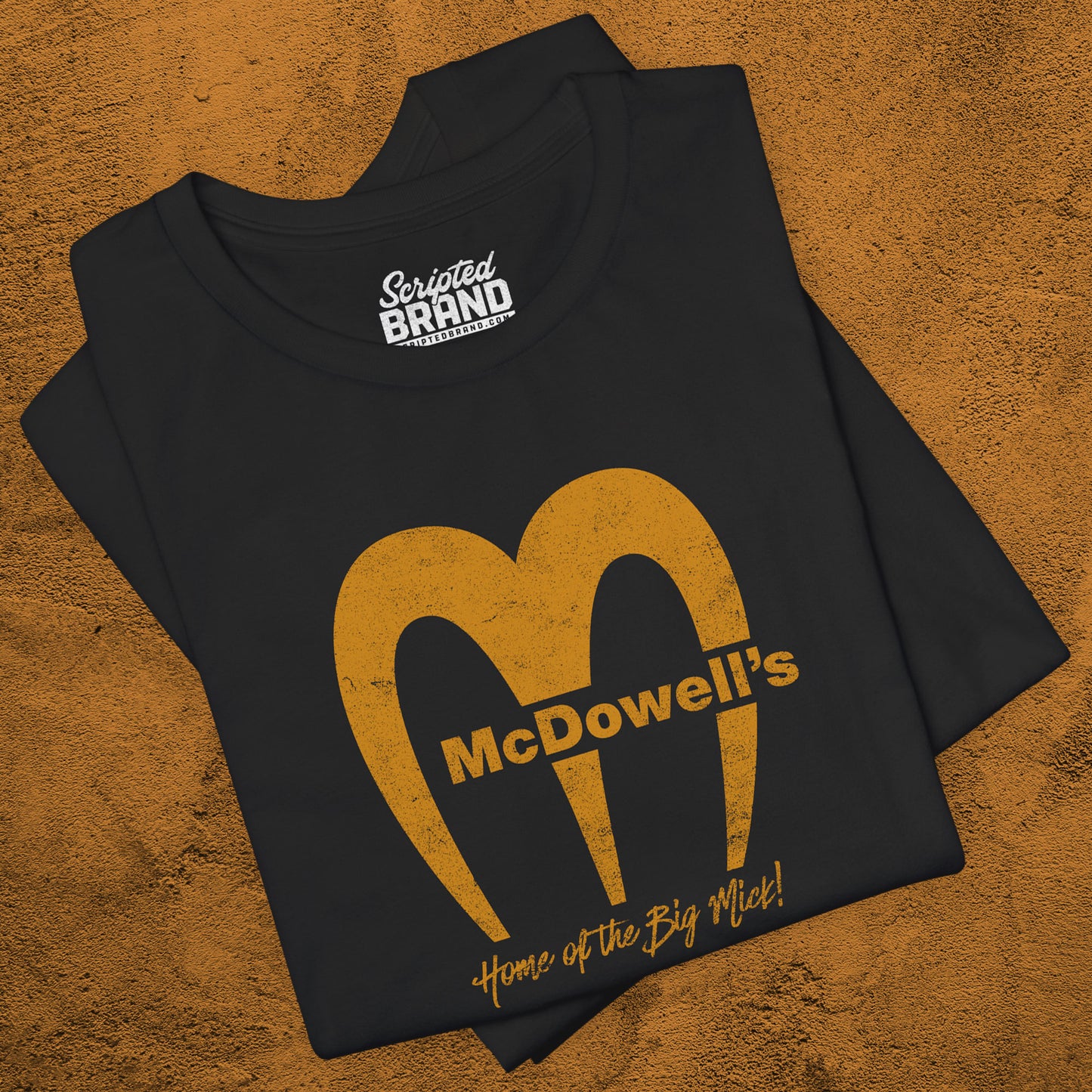 Black t-shirt featuring the McDowells logo from the movie Coming to America in a vintage distressed style.