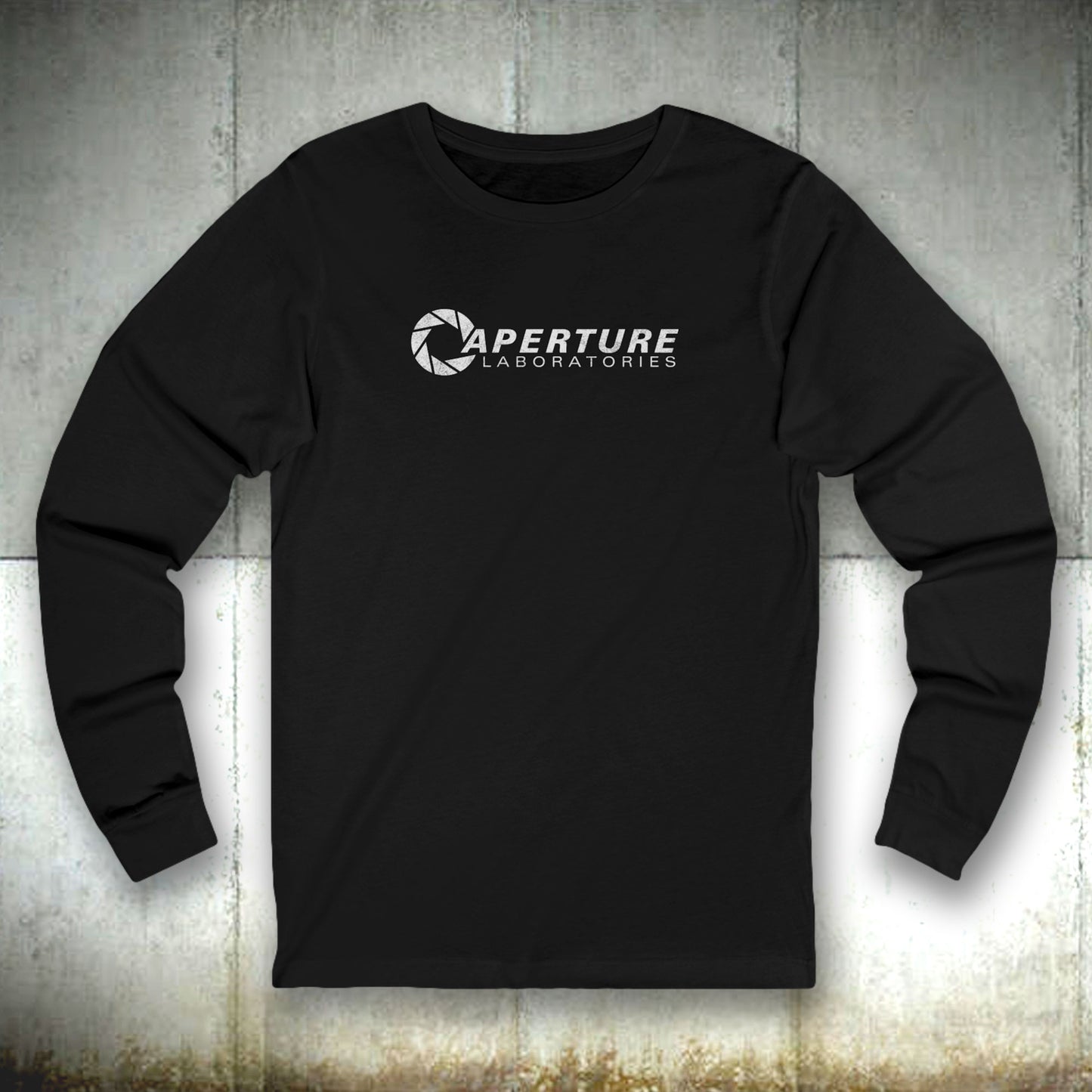 Front view of a black colored soft long-sleeve t-shirt featuring the Aperture Laboratories logo from the video game Portal and Portal 2 in a vintage distressed style, sold by ScriptedBrand.