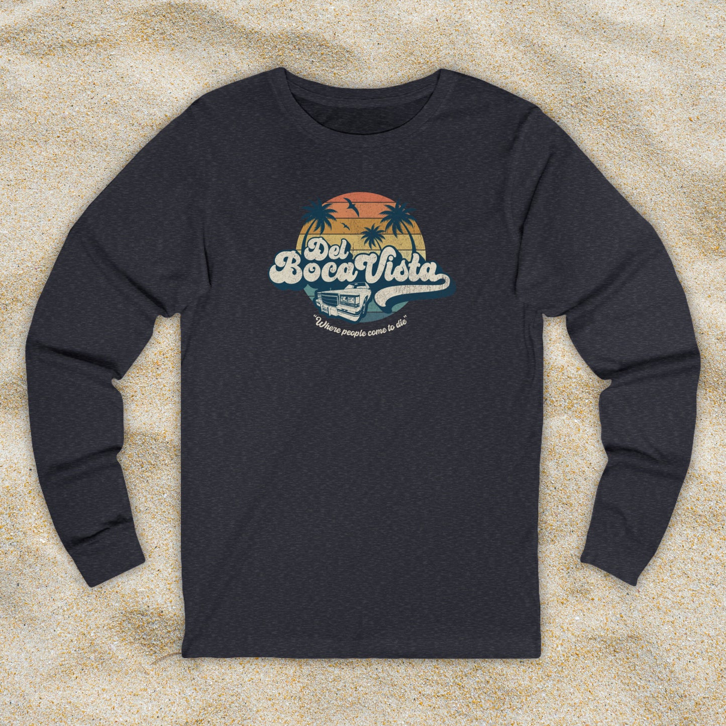 Front view of a heather navy blue Soft Bella+Canvas 3501 long-sleeve t-shirt featuring a Del Boca Vista logo graphic (uniquely designed by ScriptedBrand), including the phrase Where People Come To Die, inspired by the TV show Seinfeld, in a vintage distressed style.