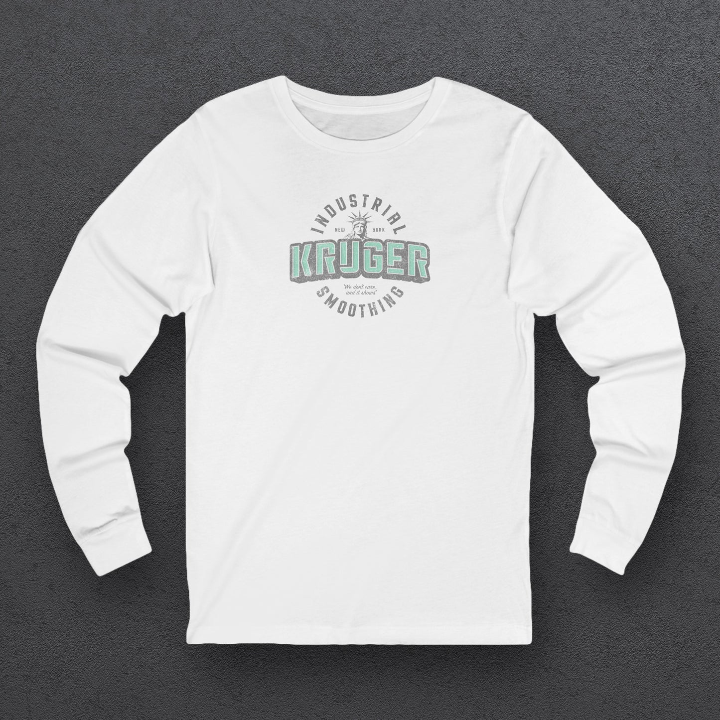 Front view of a white colored soft unisex Bella+Canvas 3501 long-sleeve t-shirt featuring a Kruger Industrial Smoothing logo graphic, designed by ScriptedBrand in a vintage distressed style, and inspired by the TV show Seinfeld. Includes the Statue of Liberty and the the slogan "We don't care and it shows".