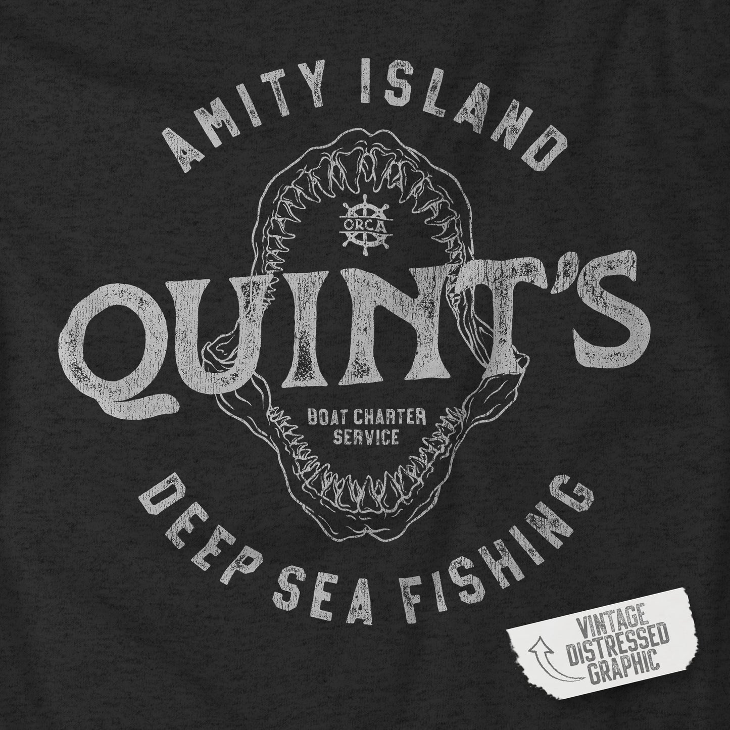 Closeup view of dark heather grey long-sleeve t-shirt with vintage Quint’s Deep Sea Fishing logo from Jaws.