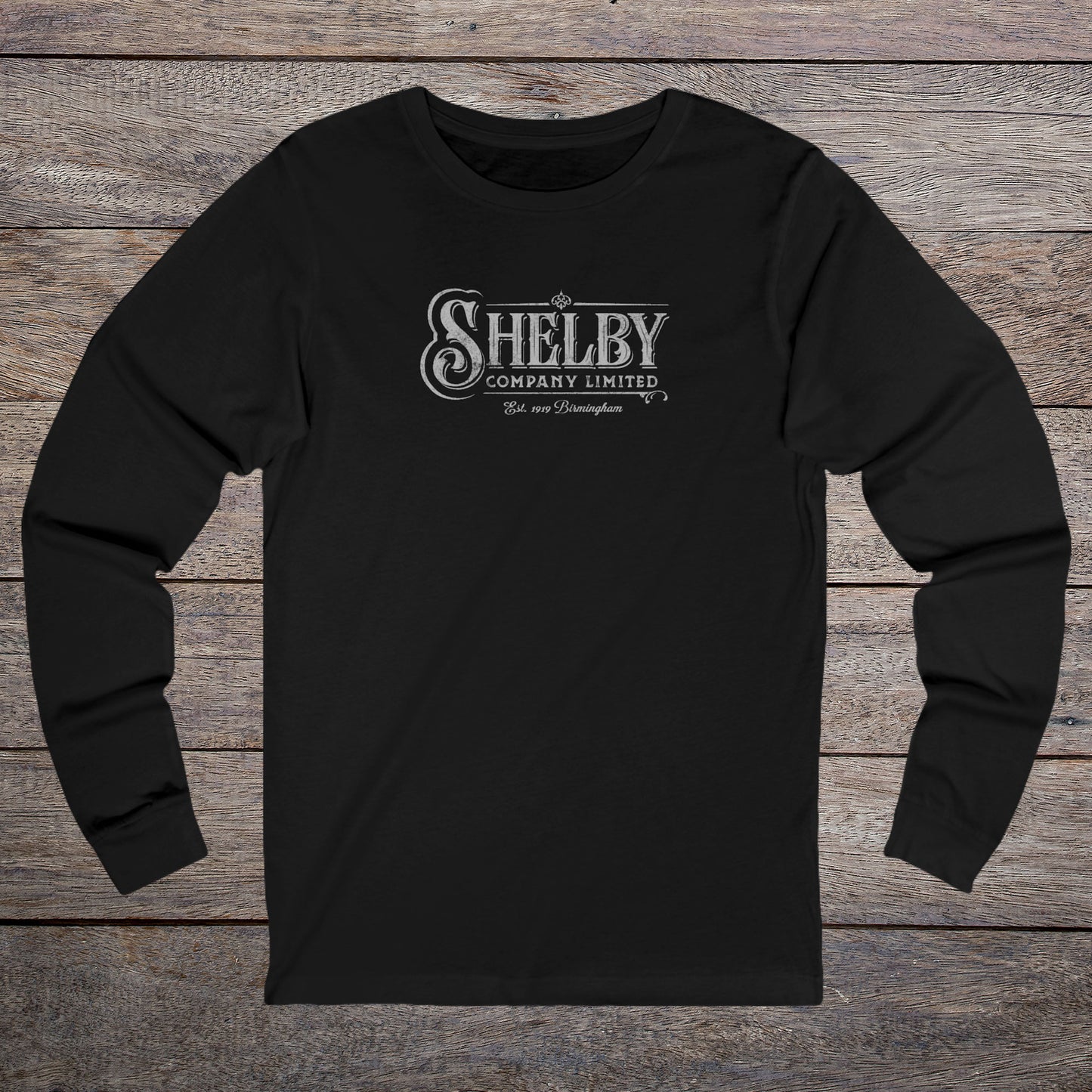 Front view of a black soft unisex Bella-Canvas 3501 long-sleeve t-shirt featuring the Shelby Company Limited logo from the show Peaky Blinders in a vintage distressed style, sold by ScriptedBrand.