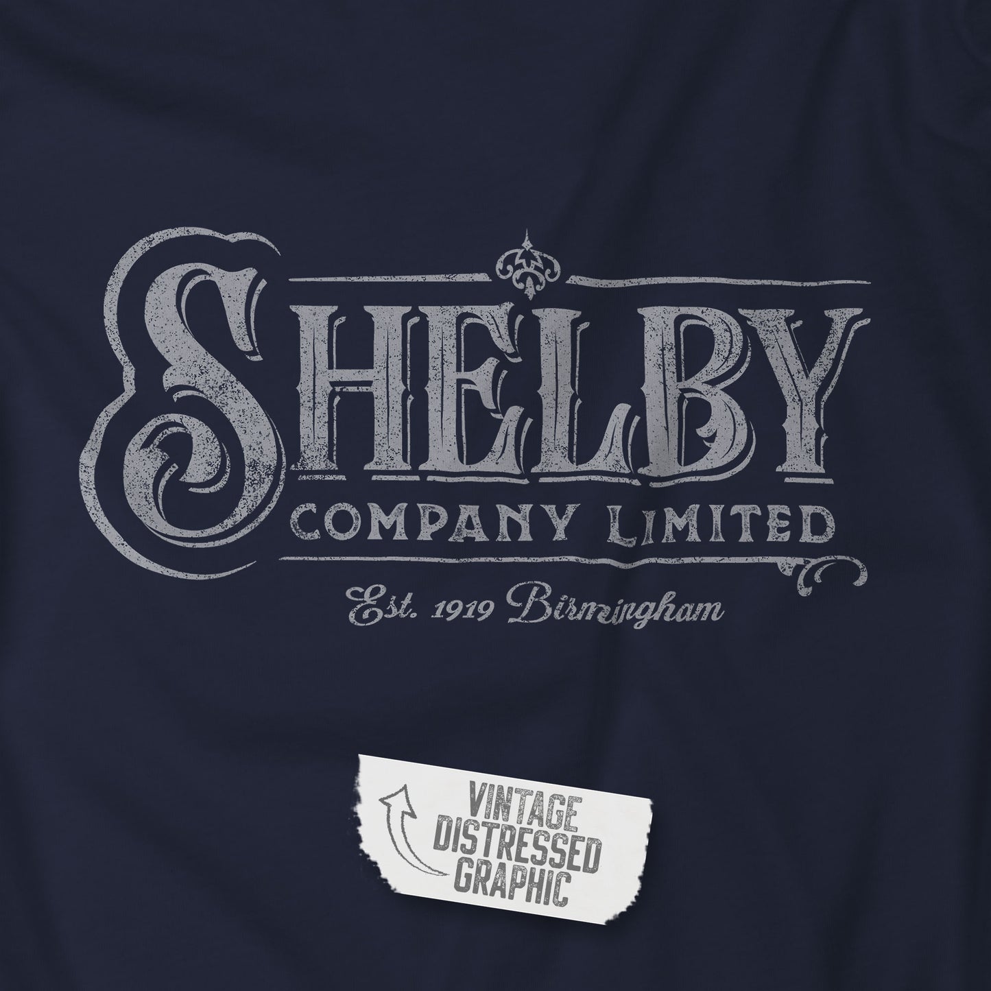 Closeup view of a navy blue soft unisex Bella-Canvas 3501 long-sleeve t-shirt featuring the Shelby Company Limited logo from the show Peaky Blinders in a vintage distressed style, sold by ScriptedBrand.