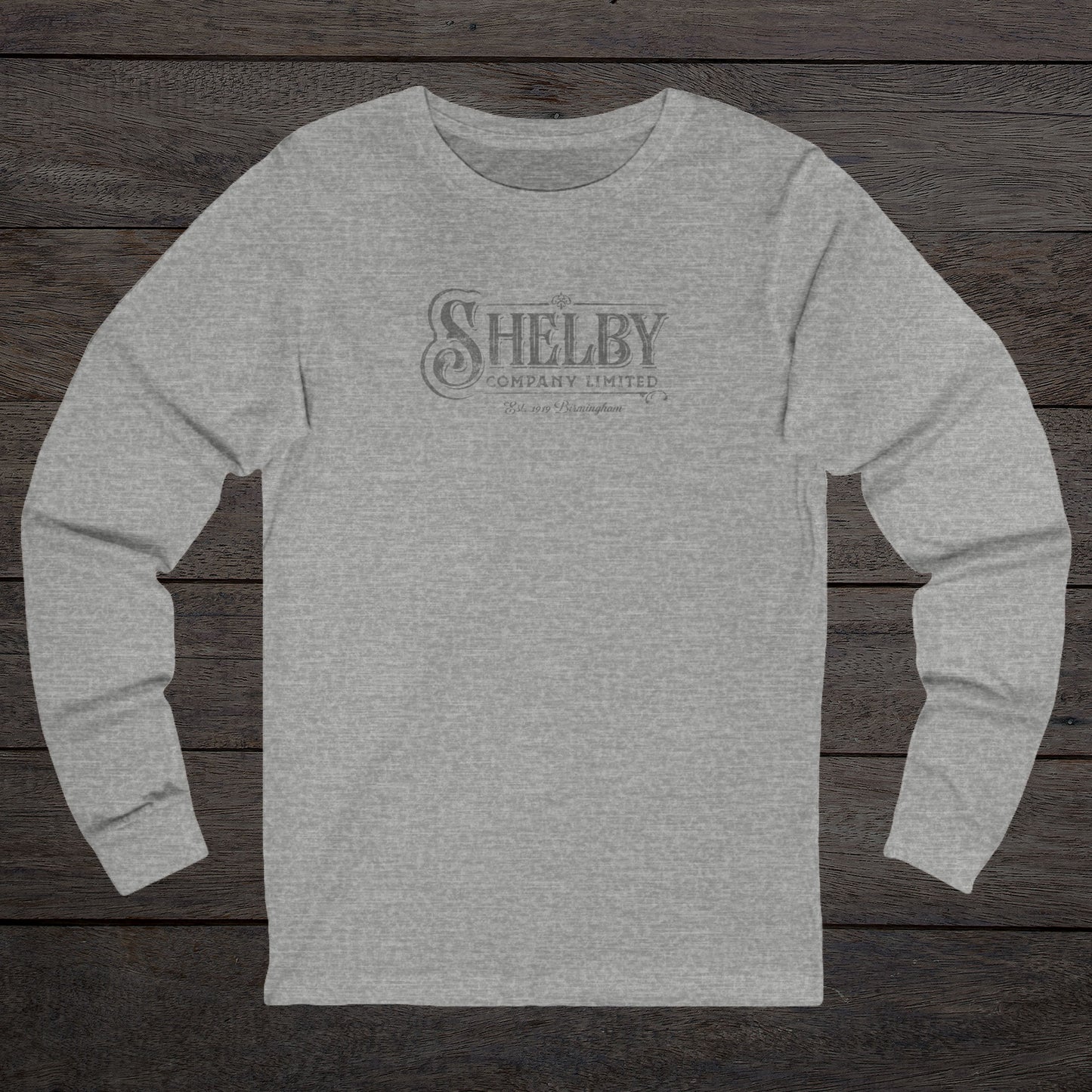 Front view of an athletic heather gray soft unisex Bella-Canvas 3501 long-sleeve t-shirt featuring the Shelby Company Limited logo from the show Peaky Blinders in a vintage distressed style, sold by ScriptedBrand.