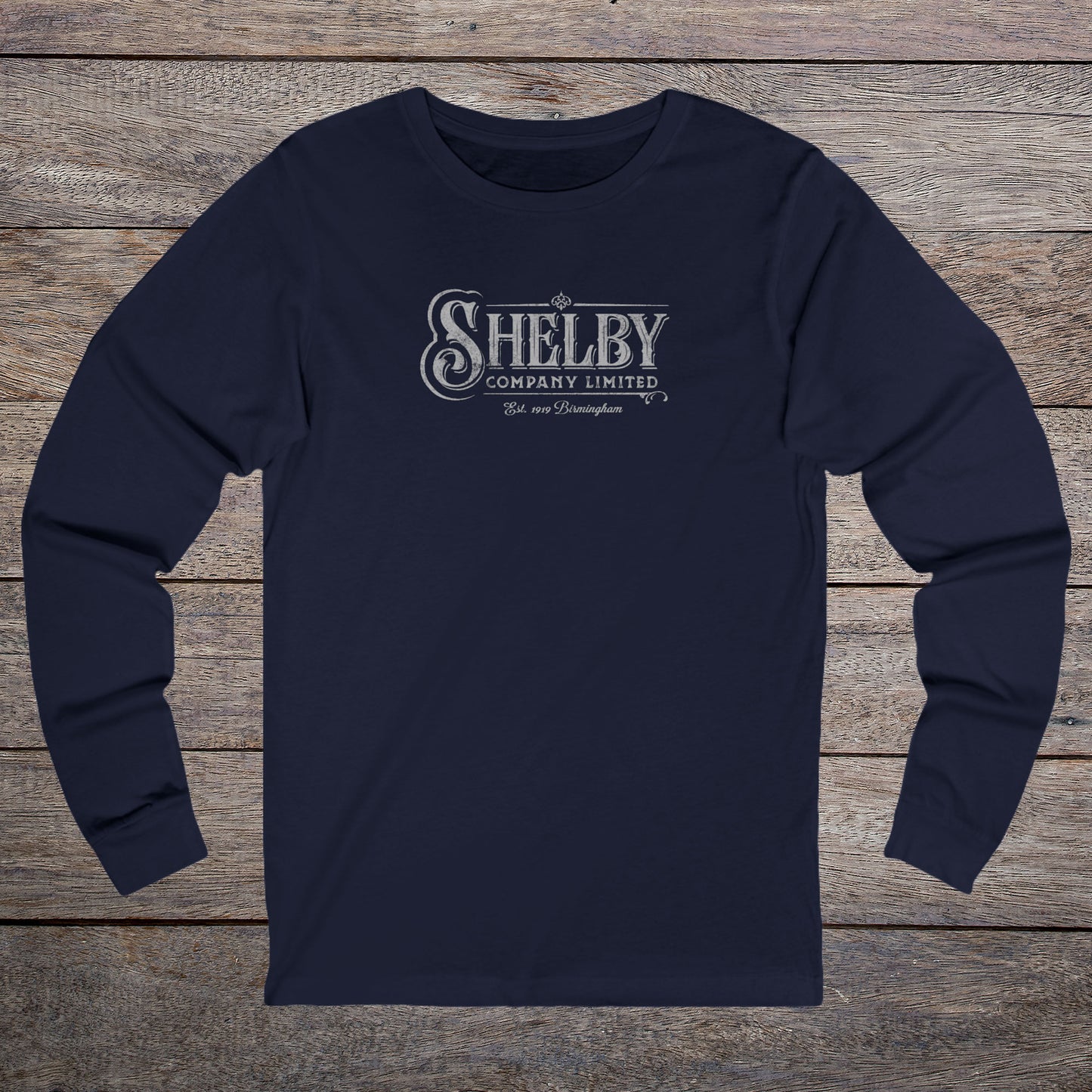Front view of a navy blue soft unisex Bella-Canvas 3501 long-sleeve t-shirt featuring the Shelby Company Limited logo from the show Peaky Blinders in a vintage distressed style, sold by ScriptedBrand.