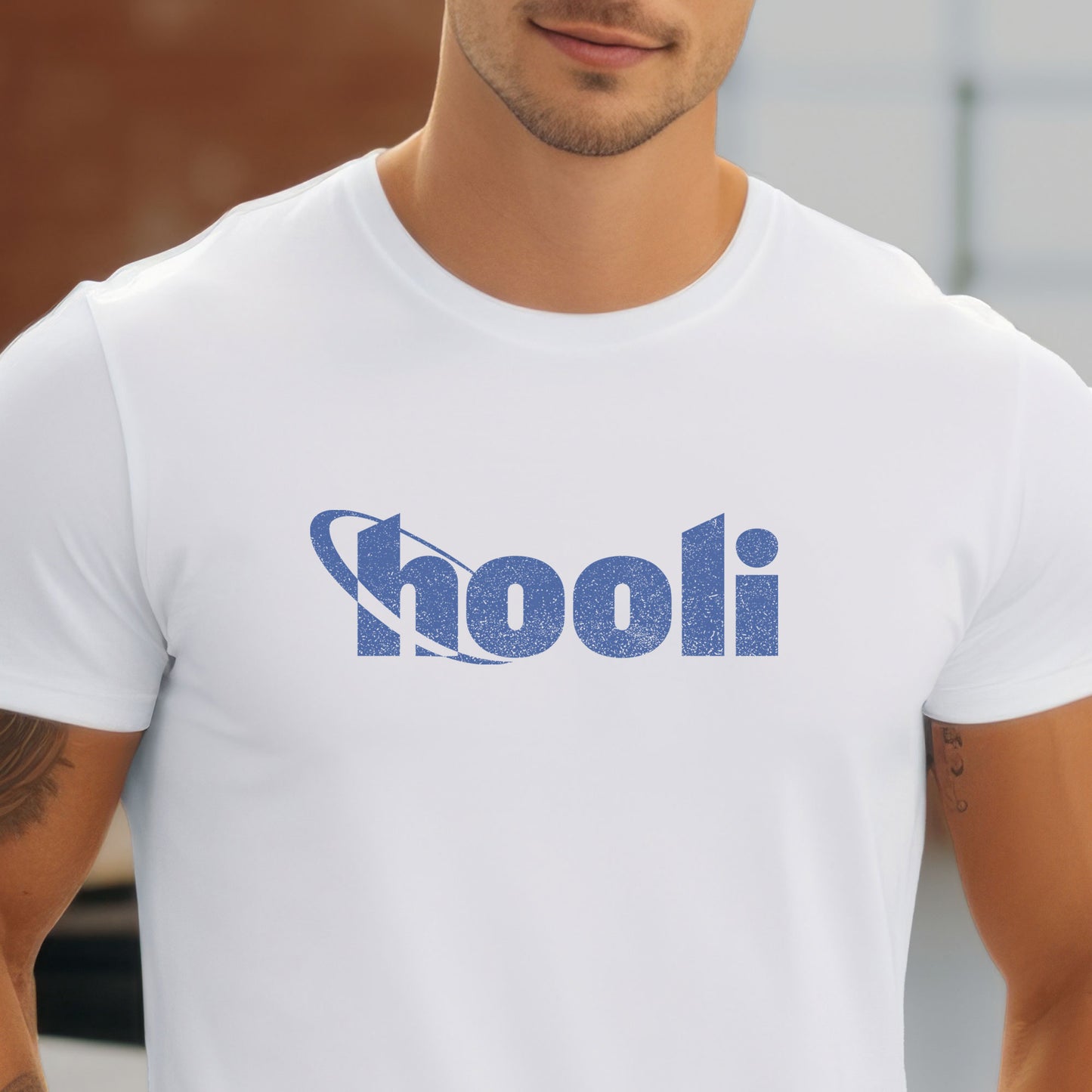 Person wearing a white t-shirt featuring the Hooli logo from the show Silicon Valley in a vintage distressed style.