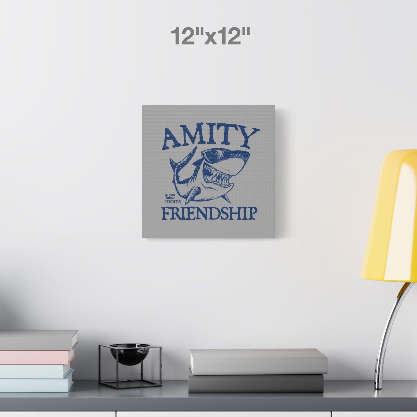 12 x 12 Funny Amity Island shark wall art canvas print inspired by Jaws with “Amity Means Friendship” and shark in sunglasses.