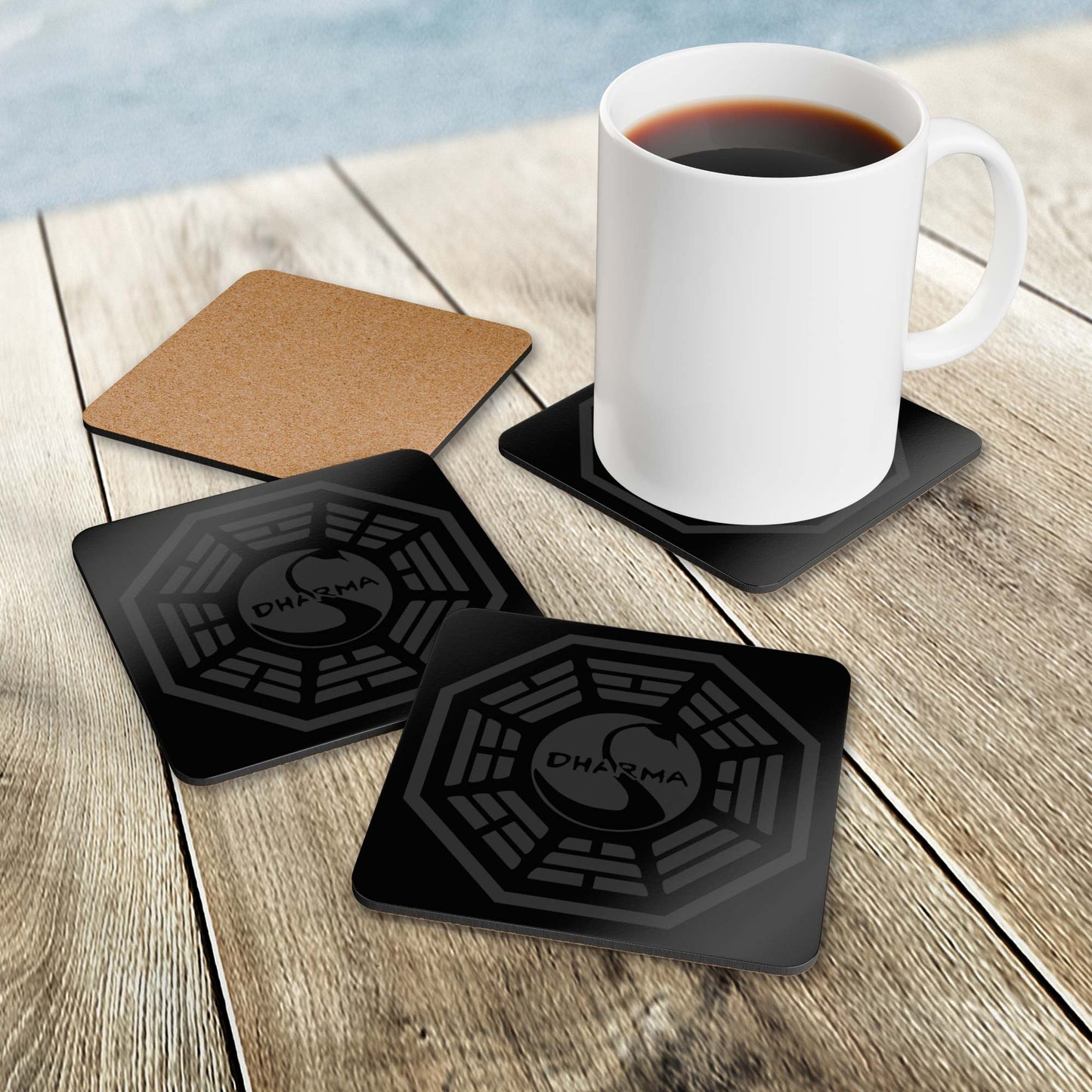 Set of 4 Corkwood Coasters on a wood surface featuring the Dharma Initiative Swan Station logo graphic from the TV show LOST.