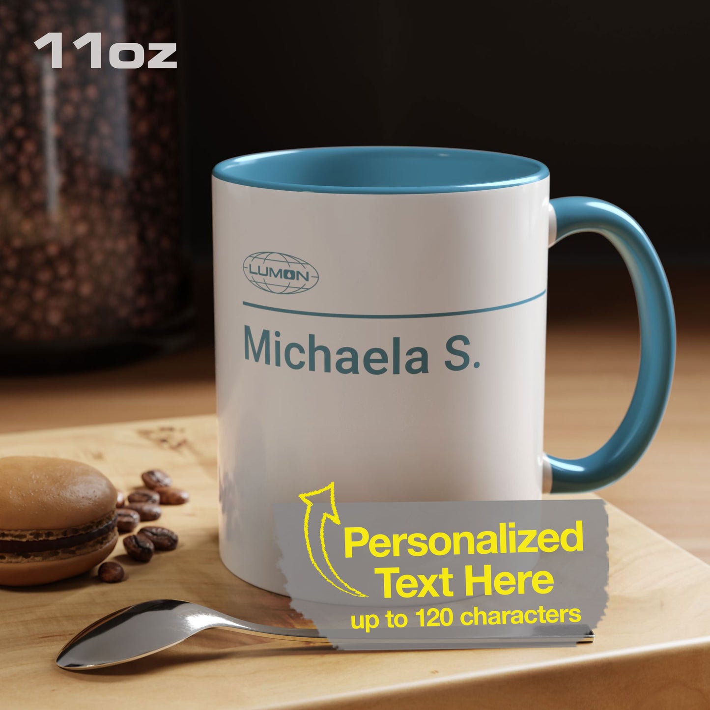 Mockup of a White Ceramic Mug (11 oz) with the blue Lumon Industries logo on one side and customizable text on the other side inspired by the Apple TV show Severance. The custom text is "Michaela S."