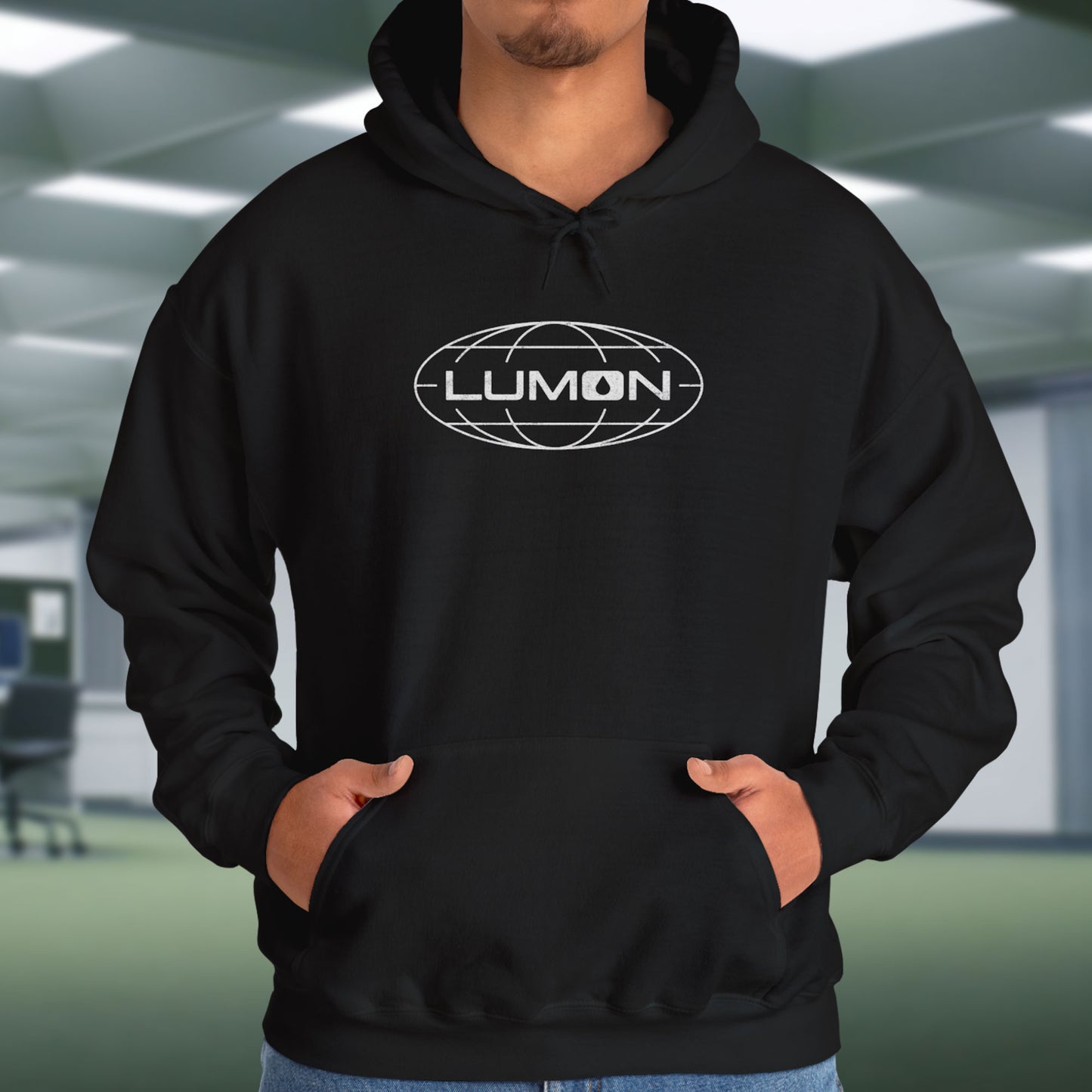 Male Model wearing a black colored Soft Unisex Heavy Blend Hooded Sweatshirt featuring the fictional Lumon Industries logo from the Apple TV show Severance.