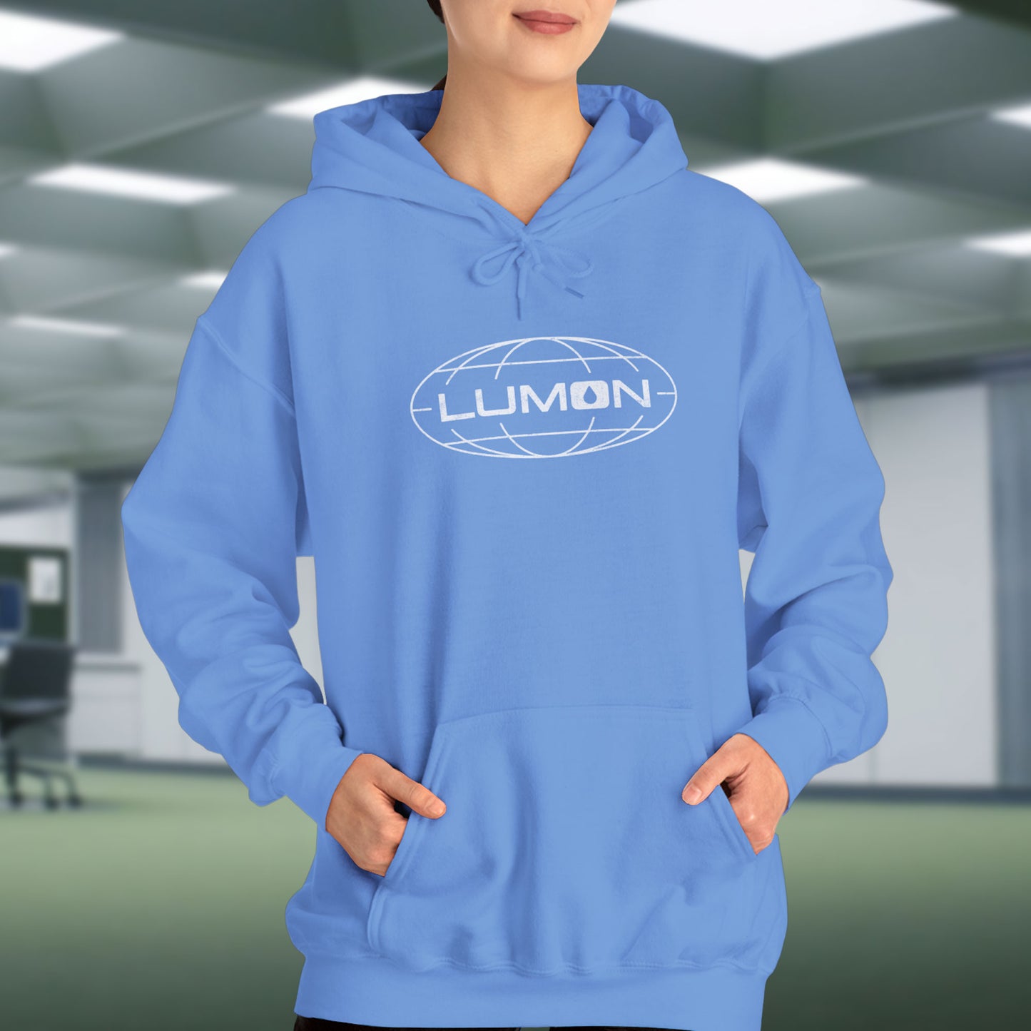 Female Model wearing a Carolina blue colored Soft Unisex Heavy Blend Hooded Sweatshirt featuring the fictional Lumon Industries logo from the Apple TV show Severance.