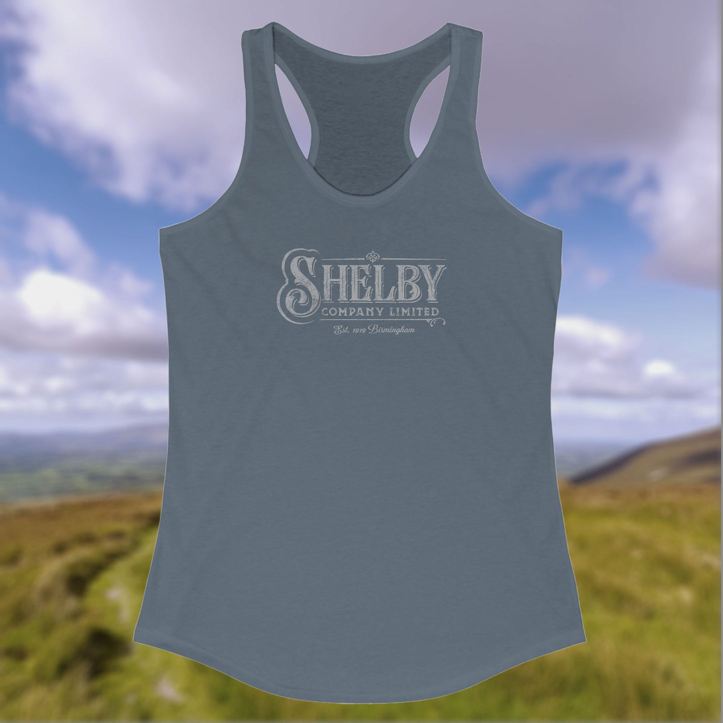 Front view of a indigo blue colored Women's Racerback Tank Top Shirt (Next Level 1533) featuring the Shelby Company LTD logo from the show Peaky Blinders in a vintage distressed style, sold by ScriptedBrand.