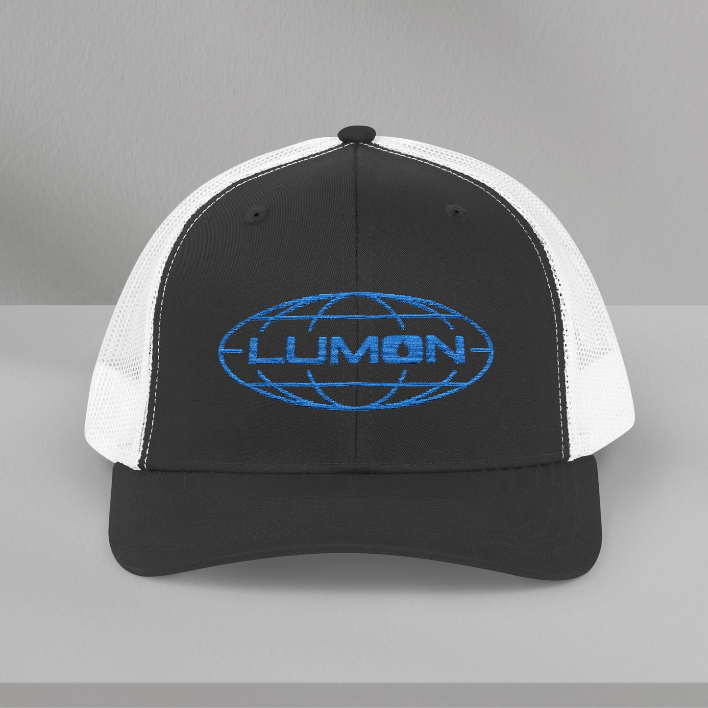 Front view of a black/white Embroidered Snapback Trucker Cap featuring the blue logo of Lumon Industries from the Apple TV Show Severance.