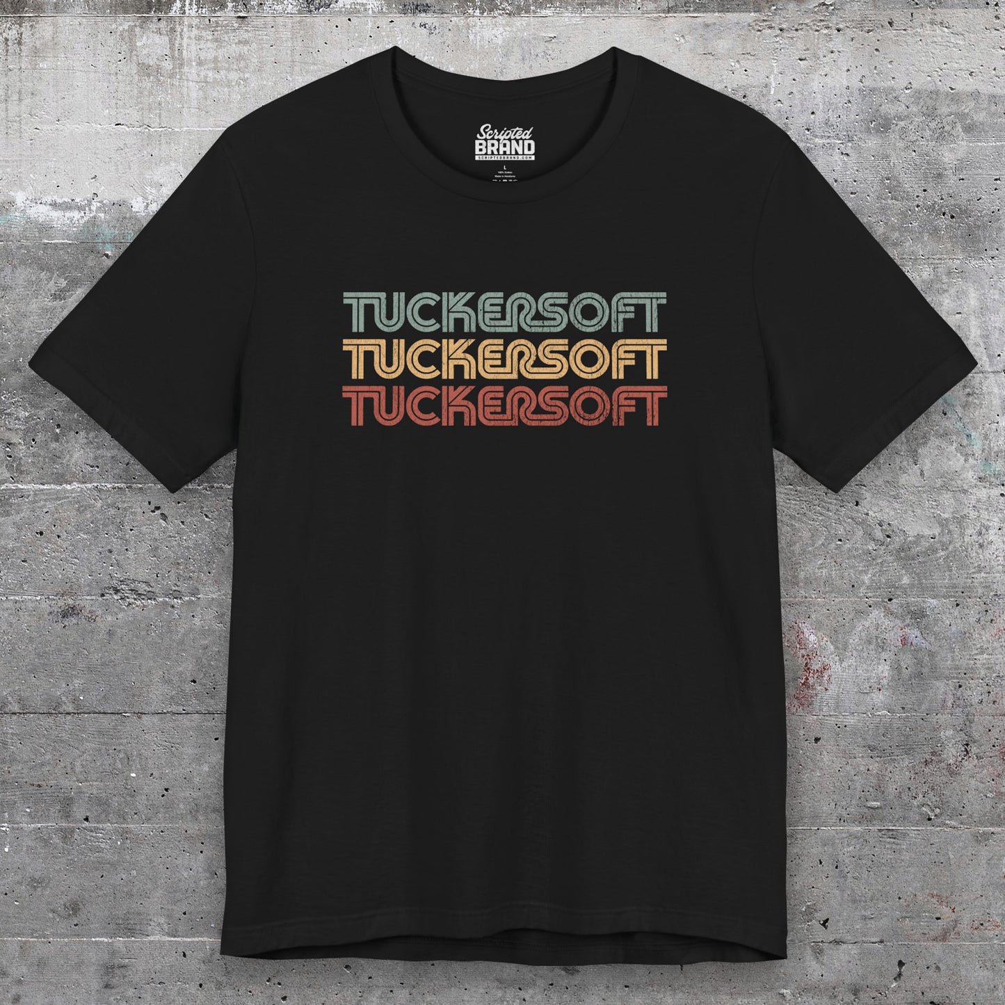 Front view of a black soft Bella+Canvas 3001 short-sleeve t-shirt tee featuring a logo graphic of the 1980s fictional video game company Tuckersoft inspired by the TV show Black Mirror and the episode Bandersnatch in a vintage distressed style, sold by ScriptedBrand.