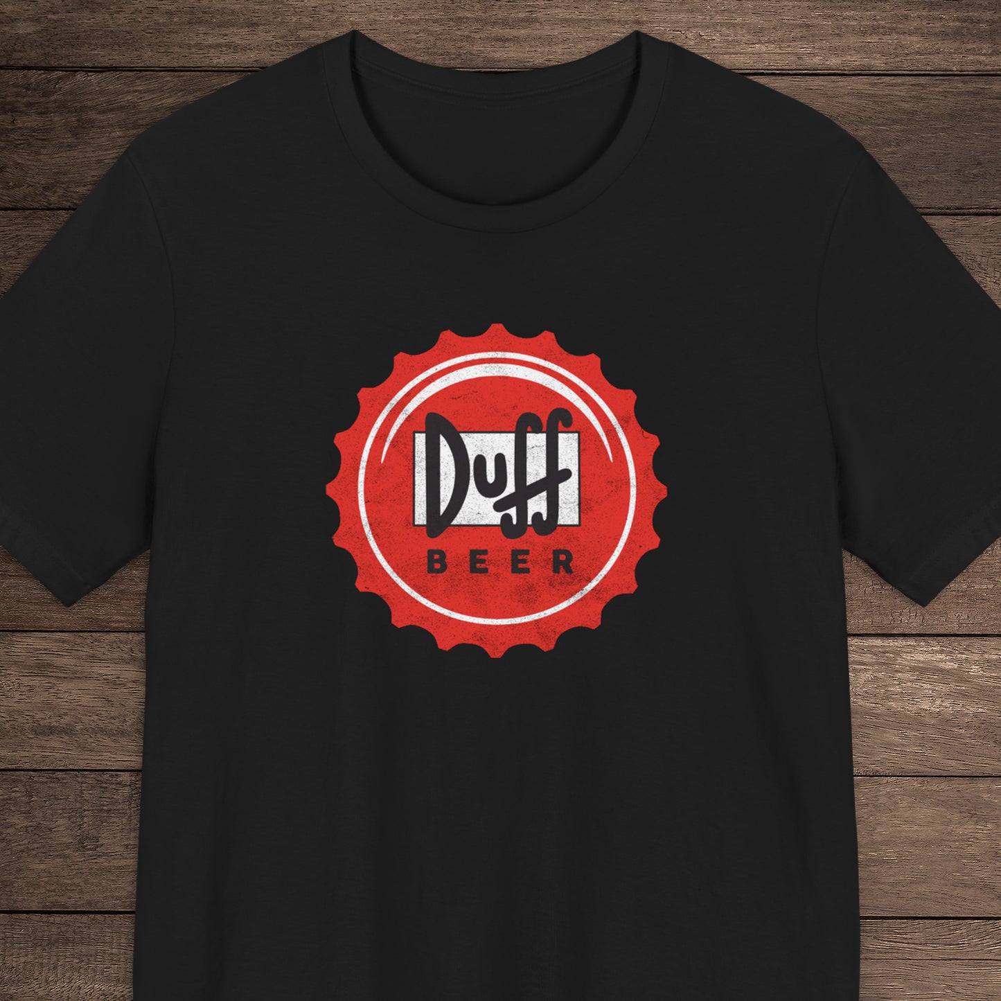Black t-shirt featuring the Duff Beer bottle cap logo from the TV Show The Simpsons in vintage distressed style.