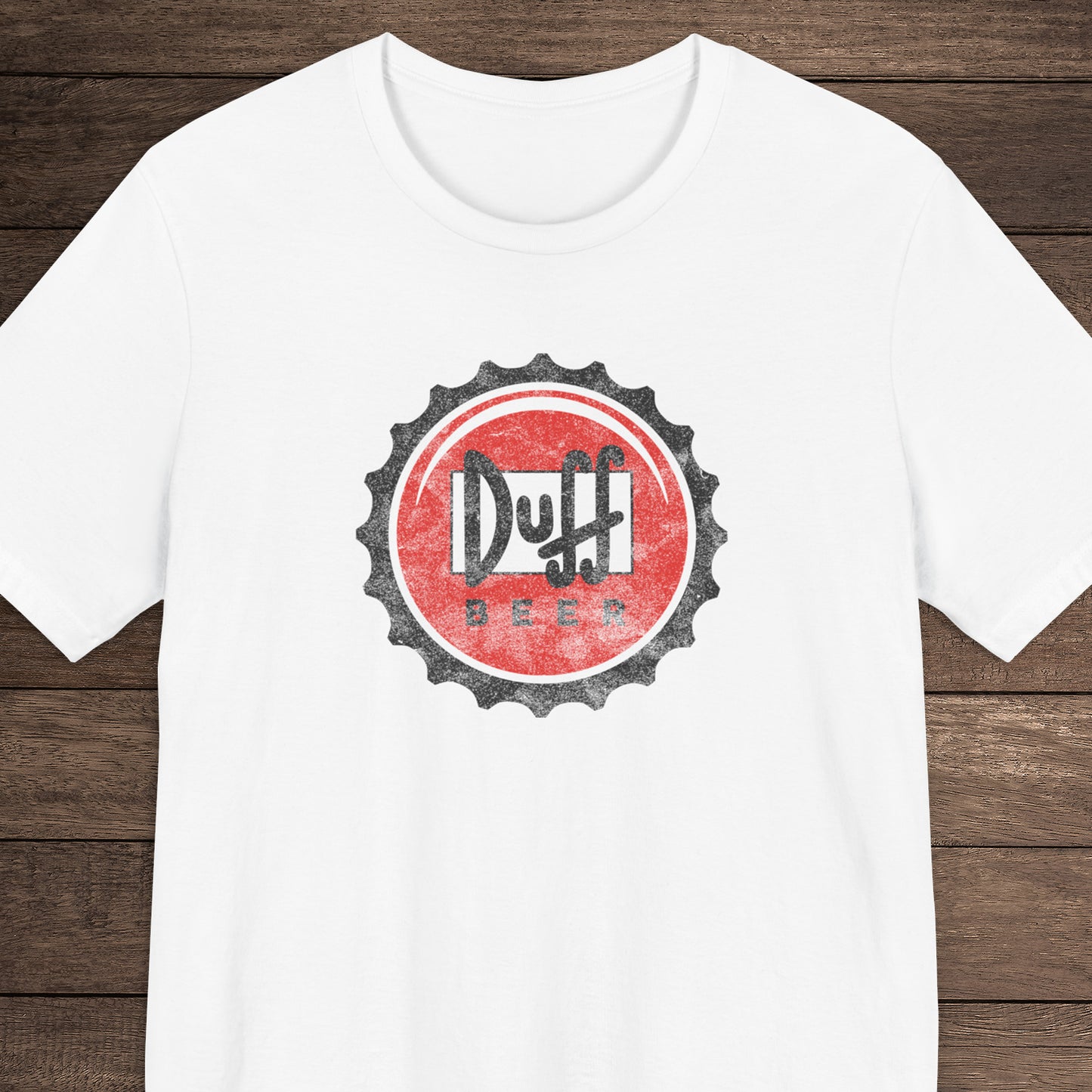 White t-shirt featuring the Duff Beer bottle cap logo from the TV Show The Simpsons in vintage distressed style.