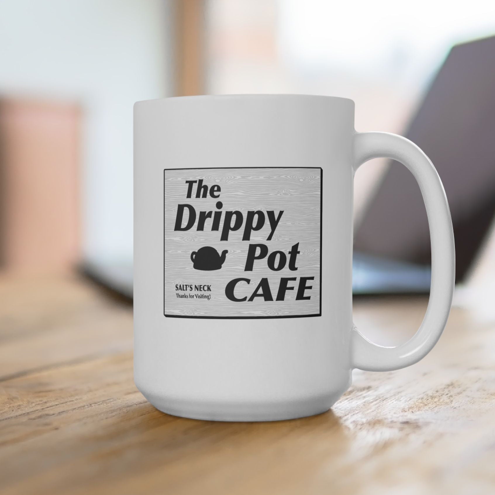 15 oz White Ceramic Mug on office desk with the Drippy Pot Cafe logo graphic from the TV show Severance