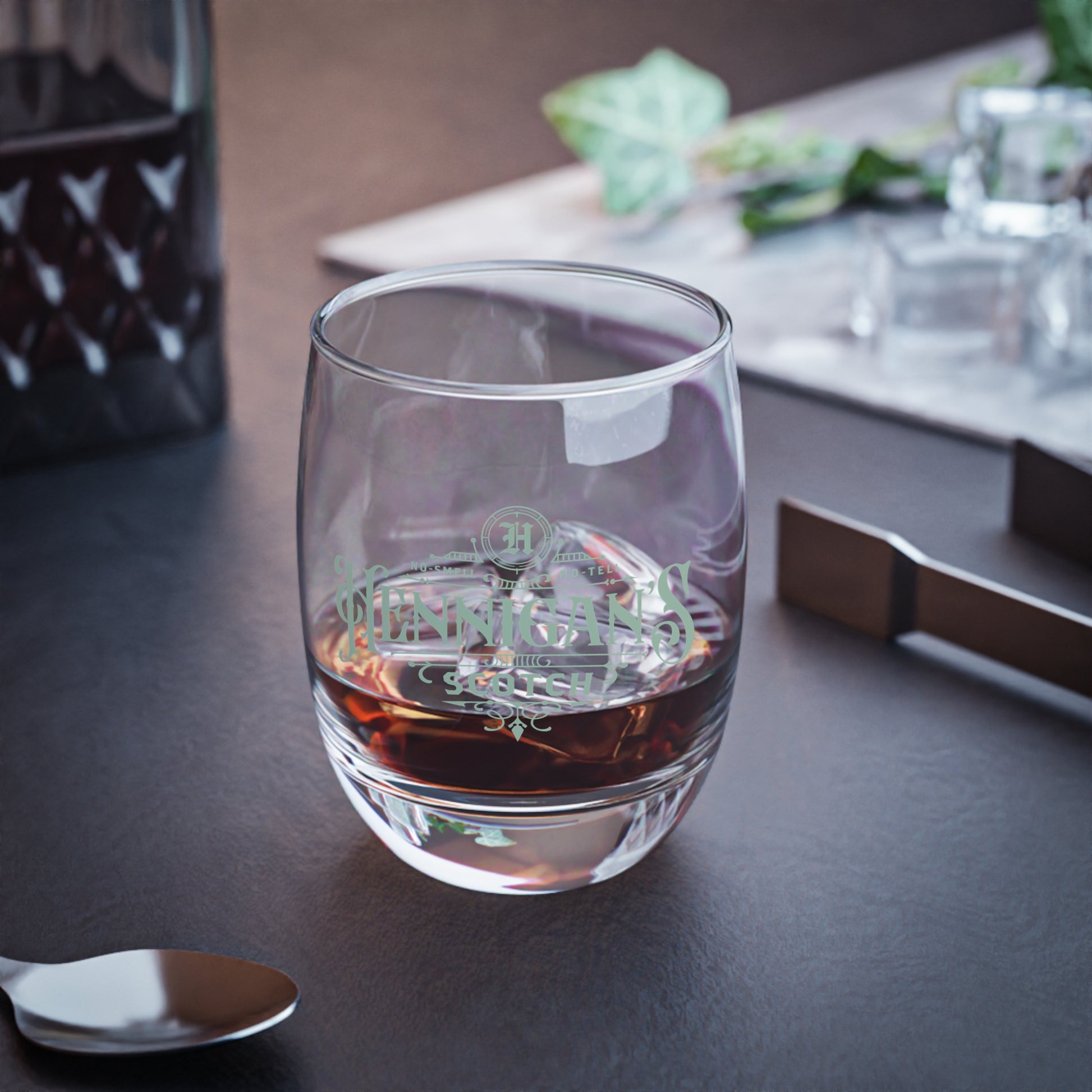 lifestyle view of a 6 ounce Whiskey Glass with Hennigan's Scotch logo designed by ScriptedBrand from the TV show Seinfeld.