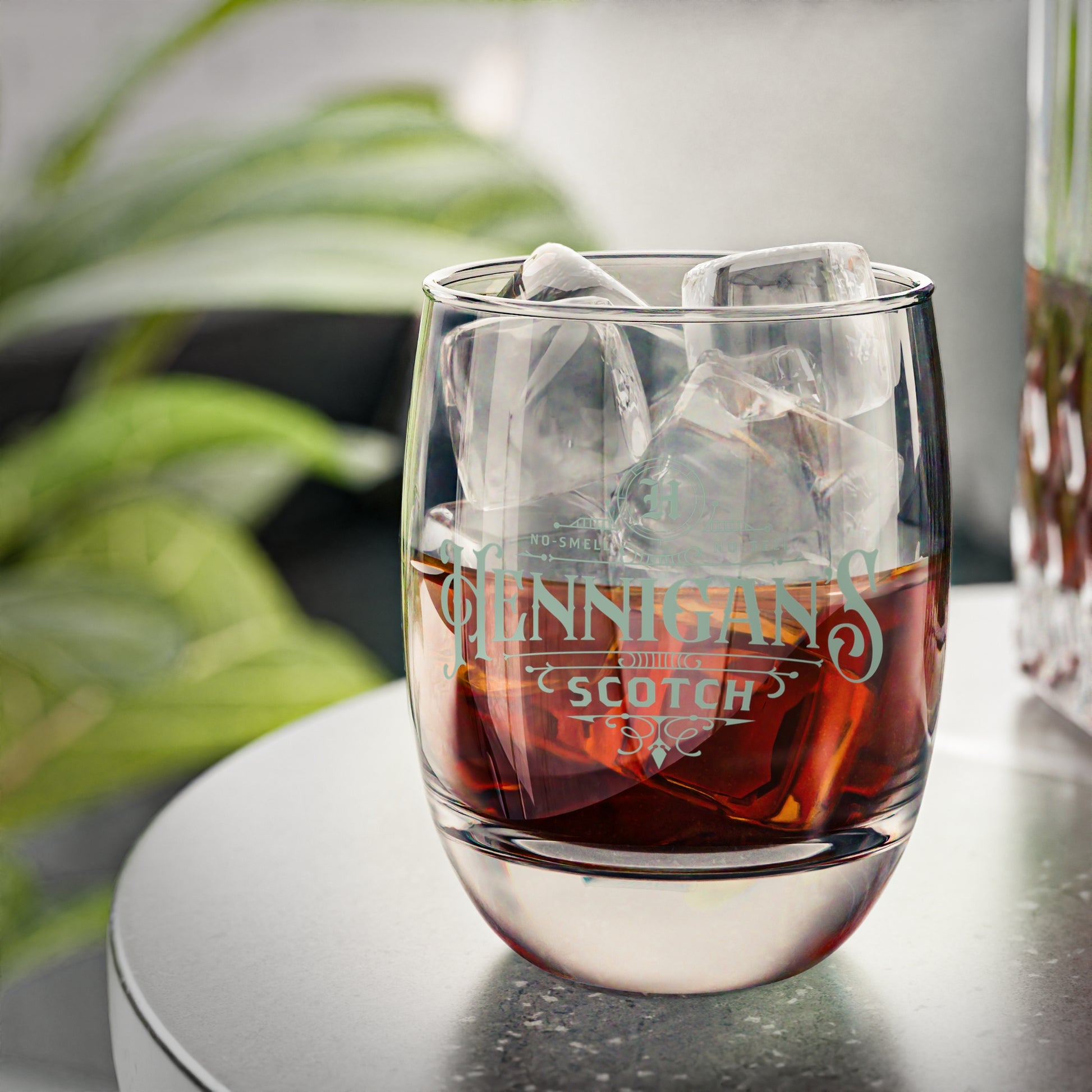 Half-filled 6 ounce Whiskey Glass with Hennigan's Scotch logo designed by ScriptedBrand from the TV show Seinfeld.