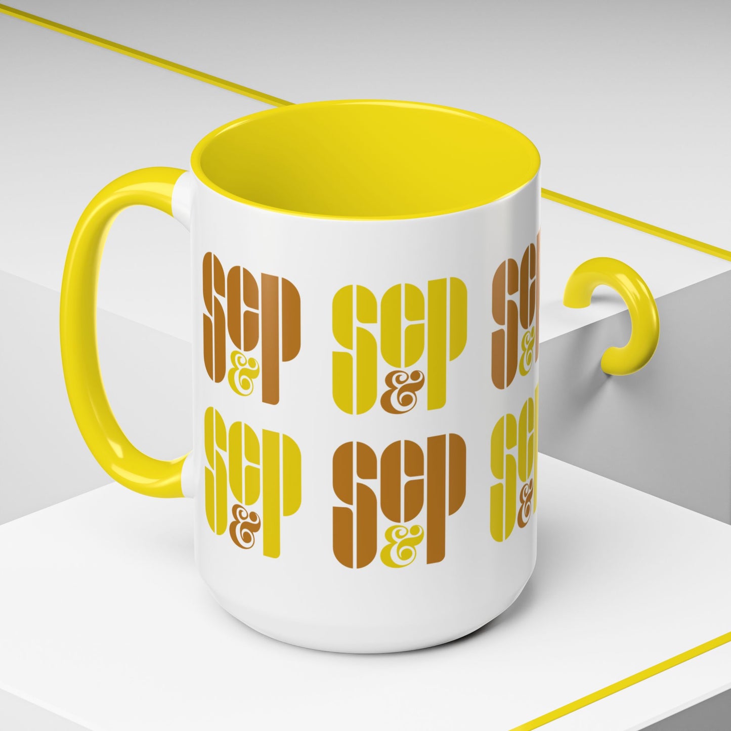 Angled view of a Mad Men 15 ounce white and yellow ceramic mug with a wraparound graphic of Sterling Cooper & Partners logos