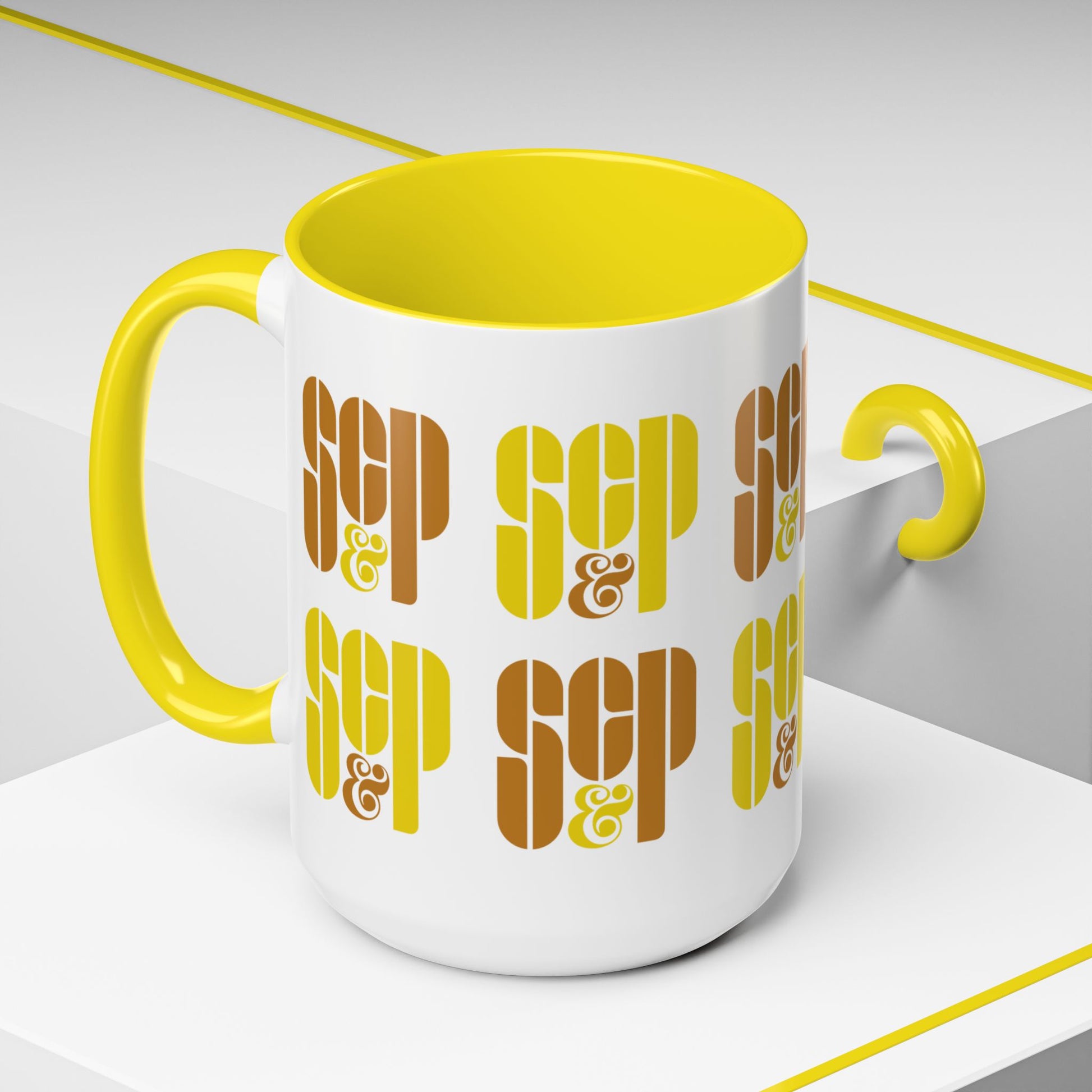 Angled view of a Mad Men 15 ounce white and yellow ceramic mug with a wraparound graphic of Sterling Cooper & Partners logos