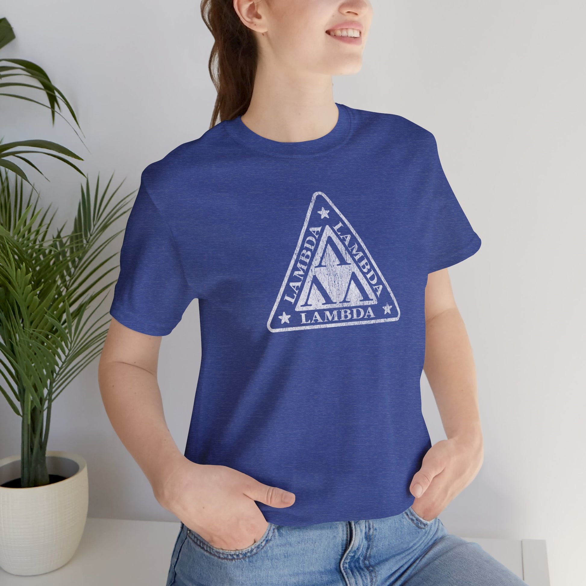 Female model wearing a heather royal blue colored Tri-Lam soft Bella+Canvas 3001 short-sleeve t-shirt featuring the logo graphic of the fictional fraternity Lambda Lambda Lambda, inspired by the movie Revenge of the Nerds, printed in a vintage distressed style, sold by ScriptedBrand.