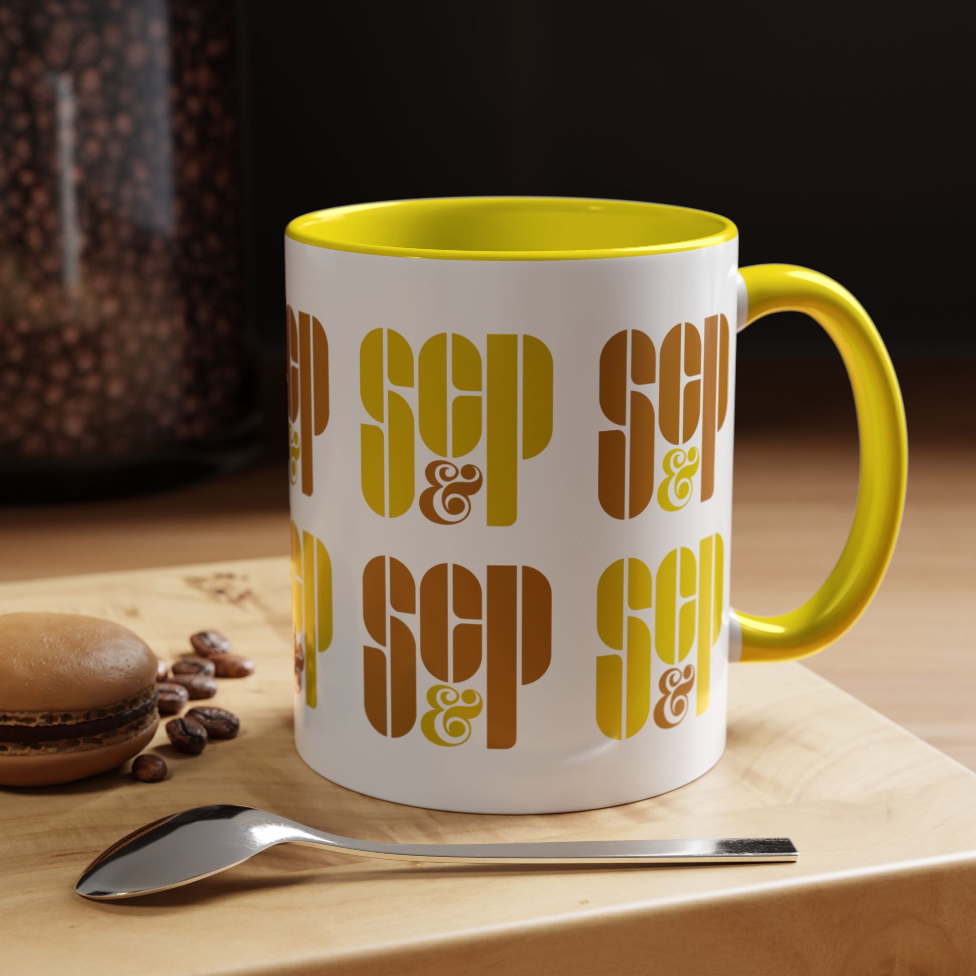 Kitchen view of a Mad Men 11 ounce white and yellow ceramic mug with a wraparound graphic of Sterling Cooper & Partners logos