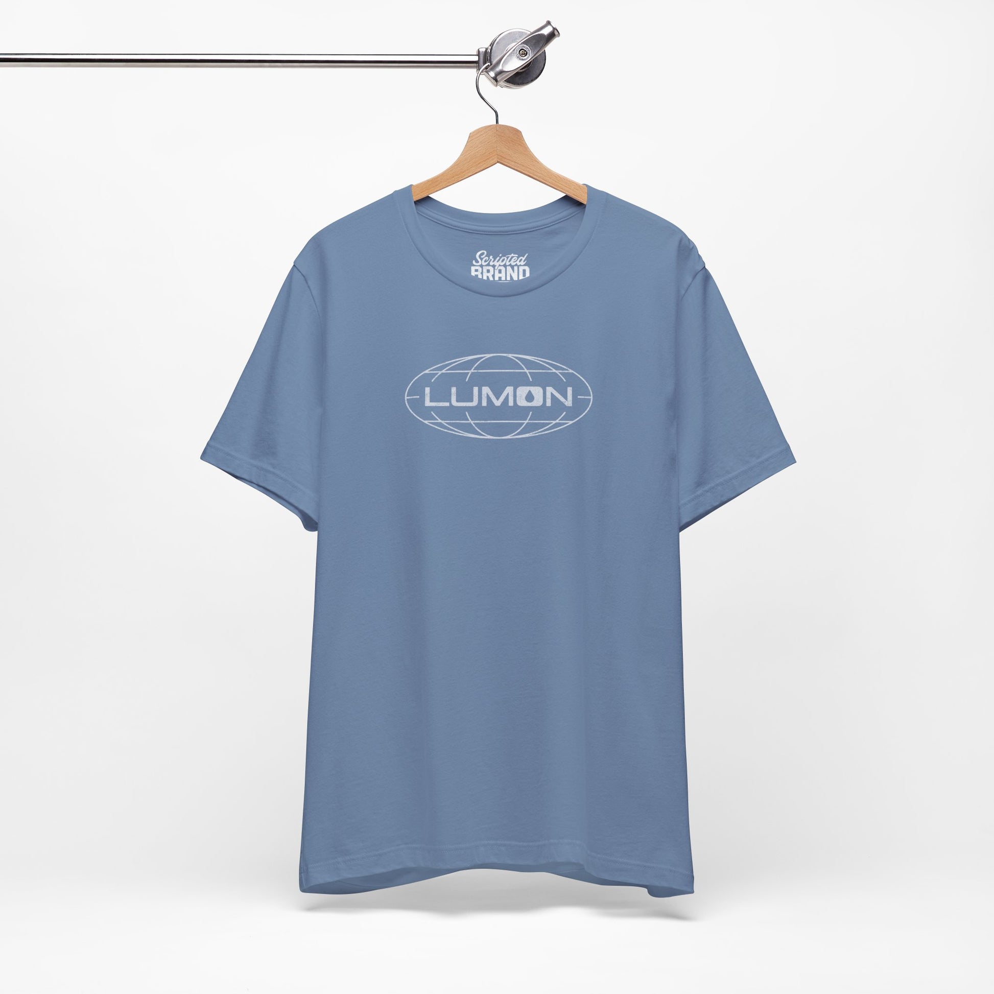 Steel blue colored soft Bella+Canvas shirtsleeve t-shirt with the Lumon Industries logo from the TV show Severance in a vintage distressed ink-stamped style, hanging on a hanger