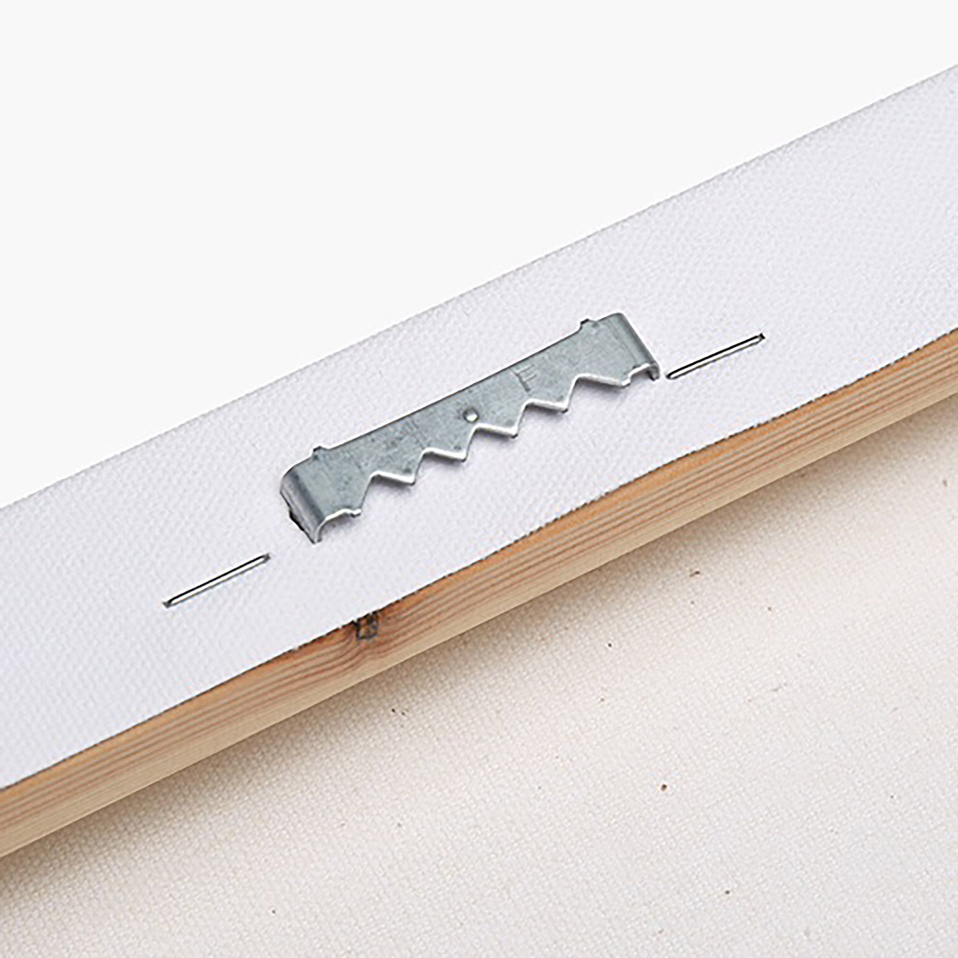 closeup of back hanging tool for stretched canvas on a wooden frame with white background