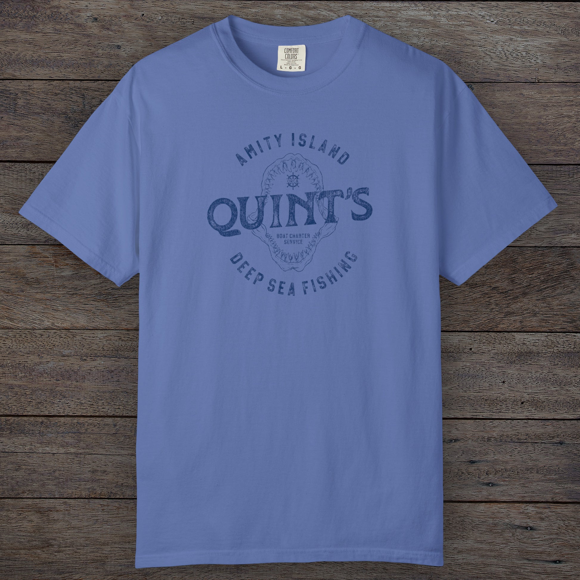 Mystic Blue Comfort Colors t-shirt with vintage Quint’s Deep Sea Fishing logo from Jaws, featuring shark graphic, distressed style.