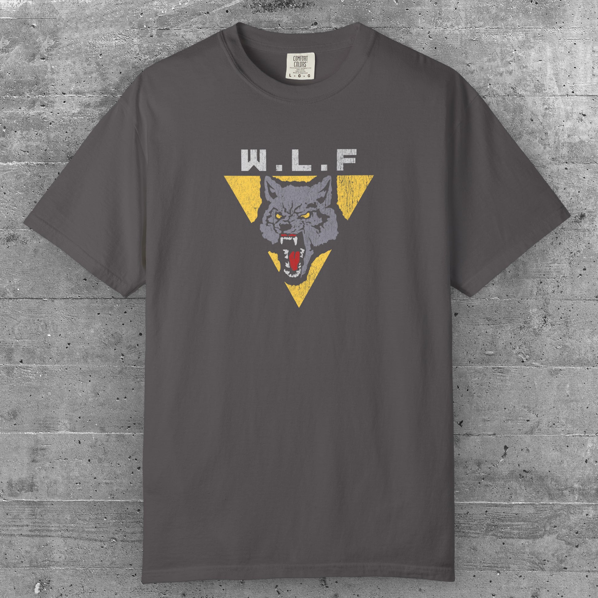 Graphite t-shirt with distressed WLF logo from The Last of Us, featuring a snarling wolf inside a yellow triangle.