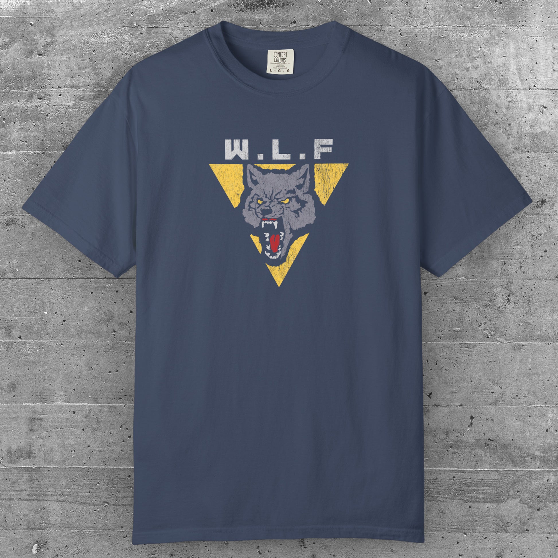 Midnight blue t-shirt with distressed WLF logo from The Last of Us, featuring a snarling wolf inside a yellow triangle.