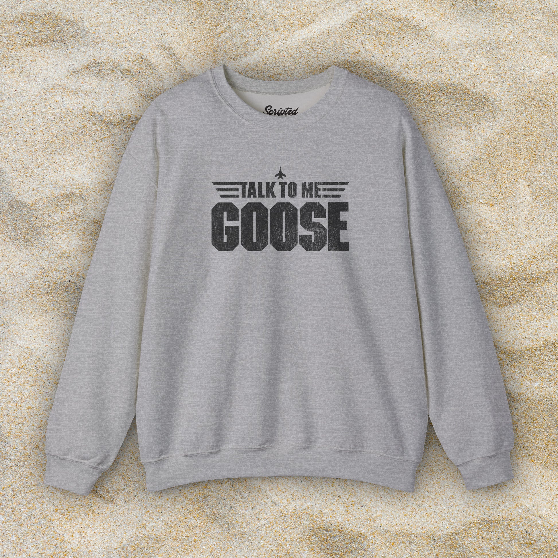 Front view of heather grey crewneck sweatshirt with distressed “Talk to Me Goose” graphic, inspired by the movie Top Gun.