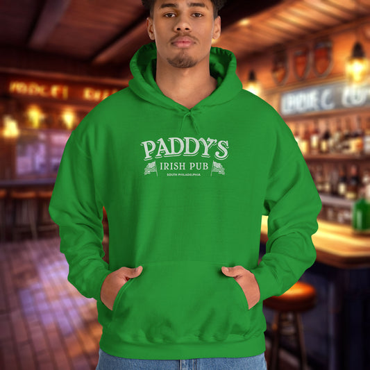 Male model wearing an Irish green colored soft unisex Hoodie Heavy Blend Hooded Sweatshirt featuring the Paddy's Pub logo graphic from the TV Show It's Always Sunny in Philadelphia, in a vintage distressed style, sold by ScriptedBrand.