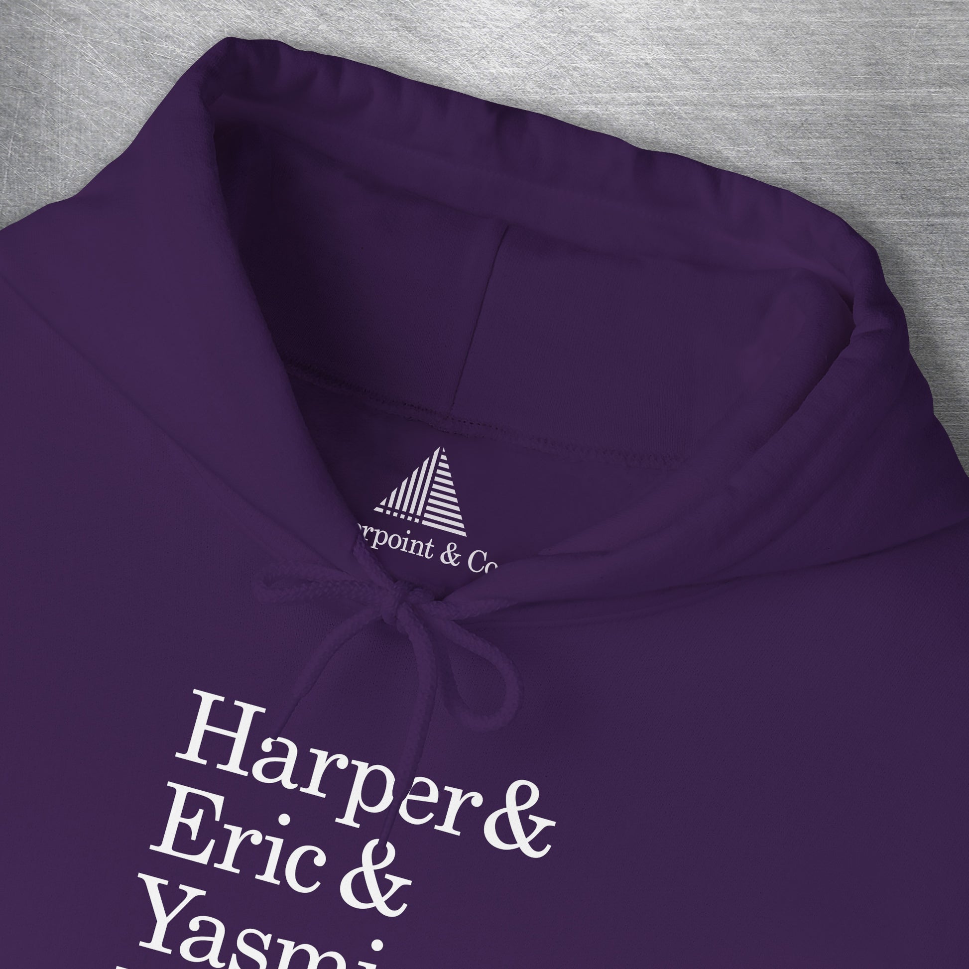 Closeup of neck tag on Purple hoodie with names Harper, Eric, Yasmin, Robert & Rishi in Pierpoint & Co. font, inspired by TV show Industry.