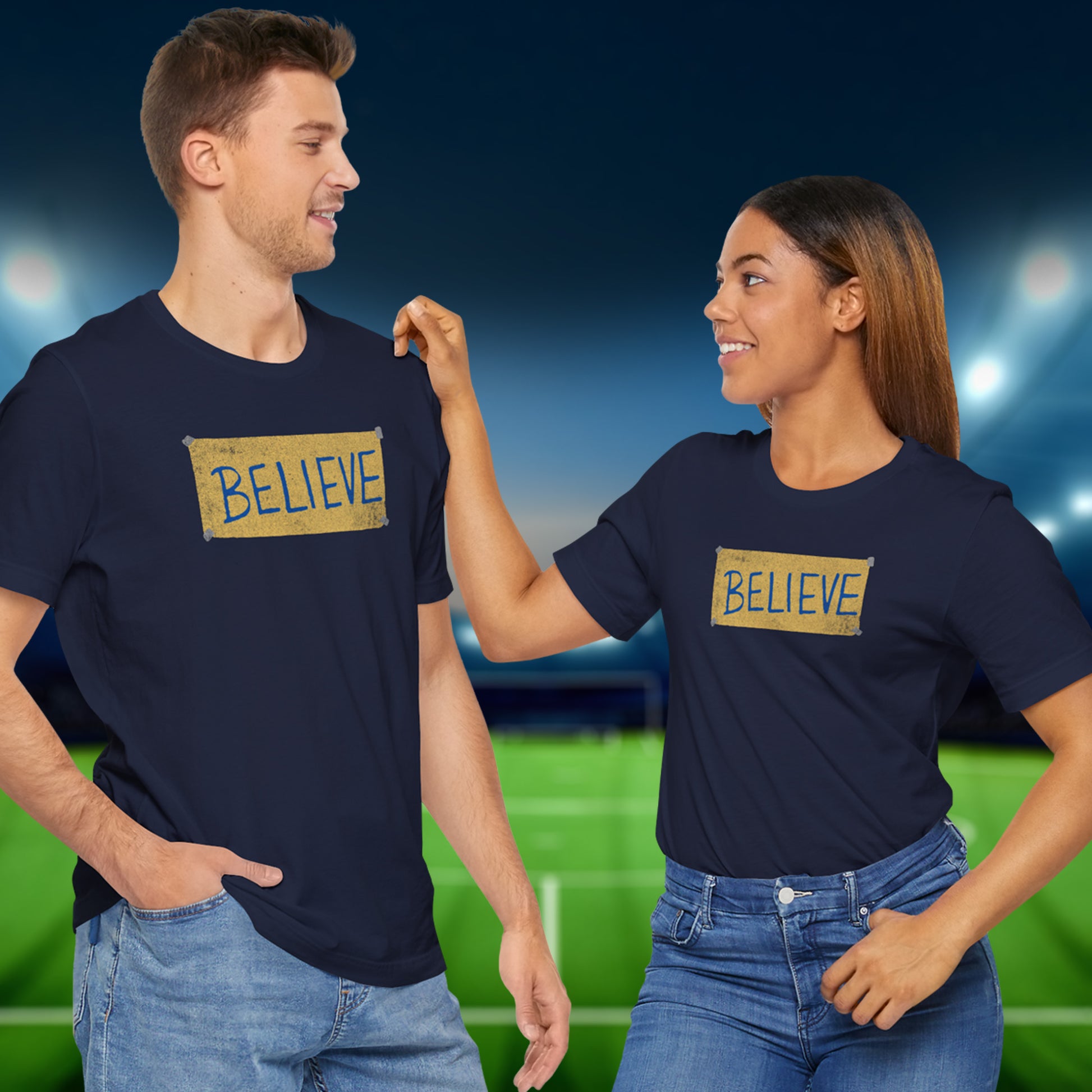 2 models wearing navy blue soft Bella+Canvas 3001 short-sleeve t-shirts featuring a logo graphic of the BELIEVE sign Ted Lasso hung in the fictional English soccer team AFC Richmond locker room, inspired by the TV show Ted Lasso in a vintage distressed style, sold by ScriptedBrand.