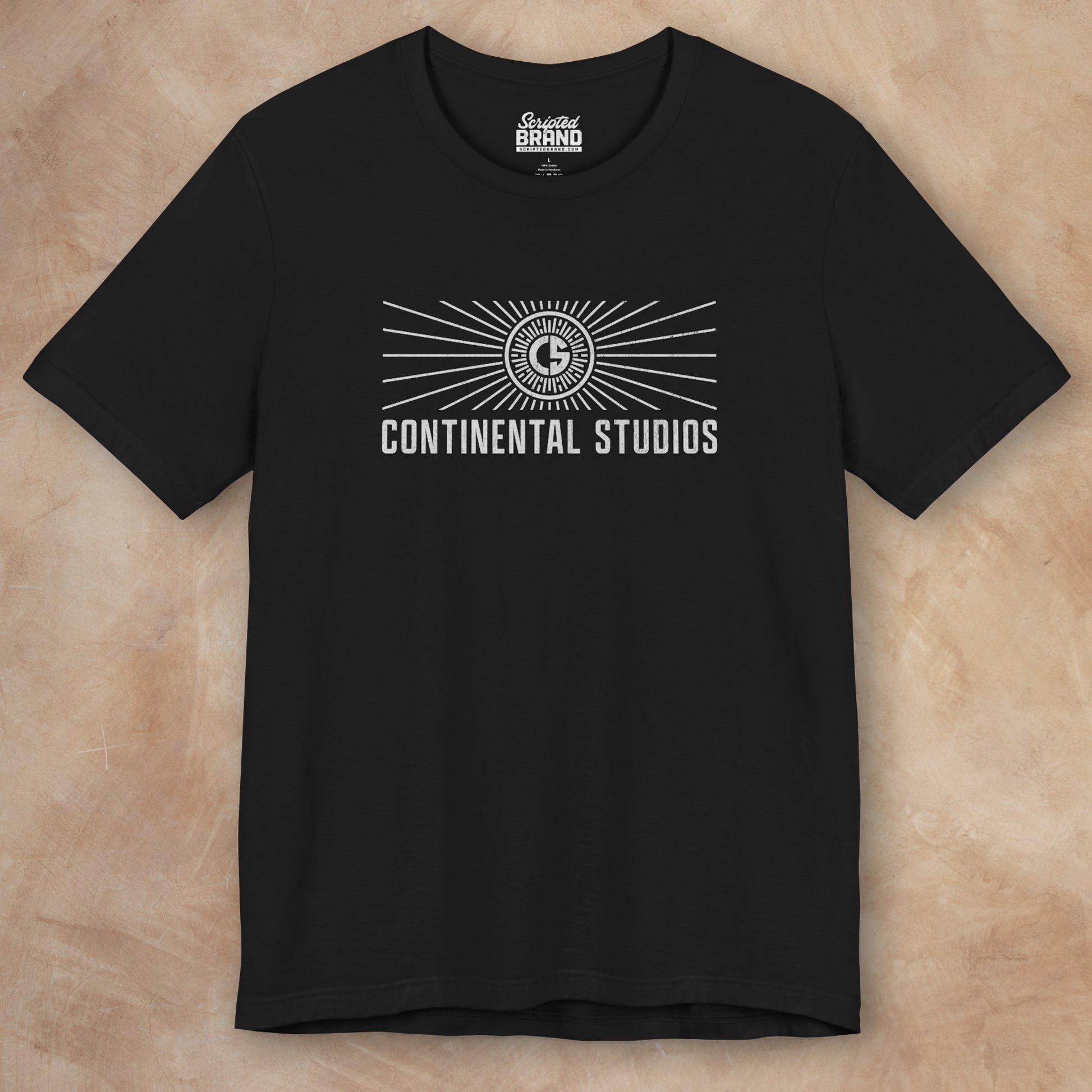 Front view of a black colored Soft Bella+Canvas 3001 short-sleeve t-shirt featuring the logo graphic of the fictional movie studio Continental Studios inspired by the Apple TV show The Studio in a vintage distressed style, sold by ScriptedBrand.