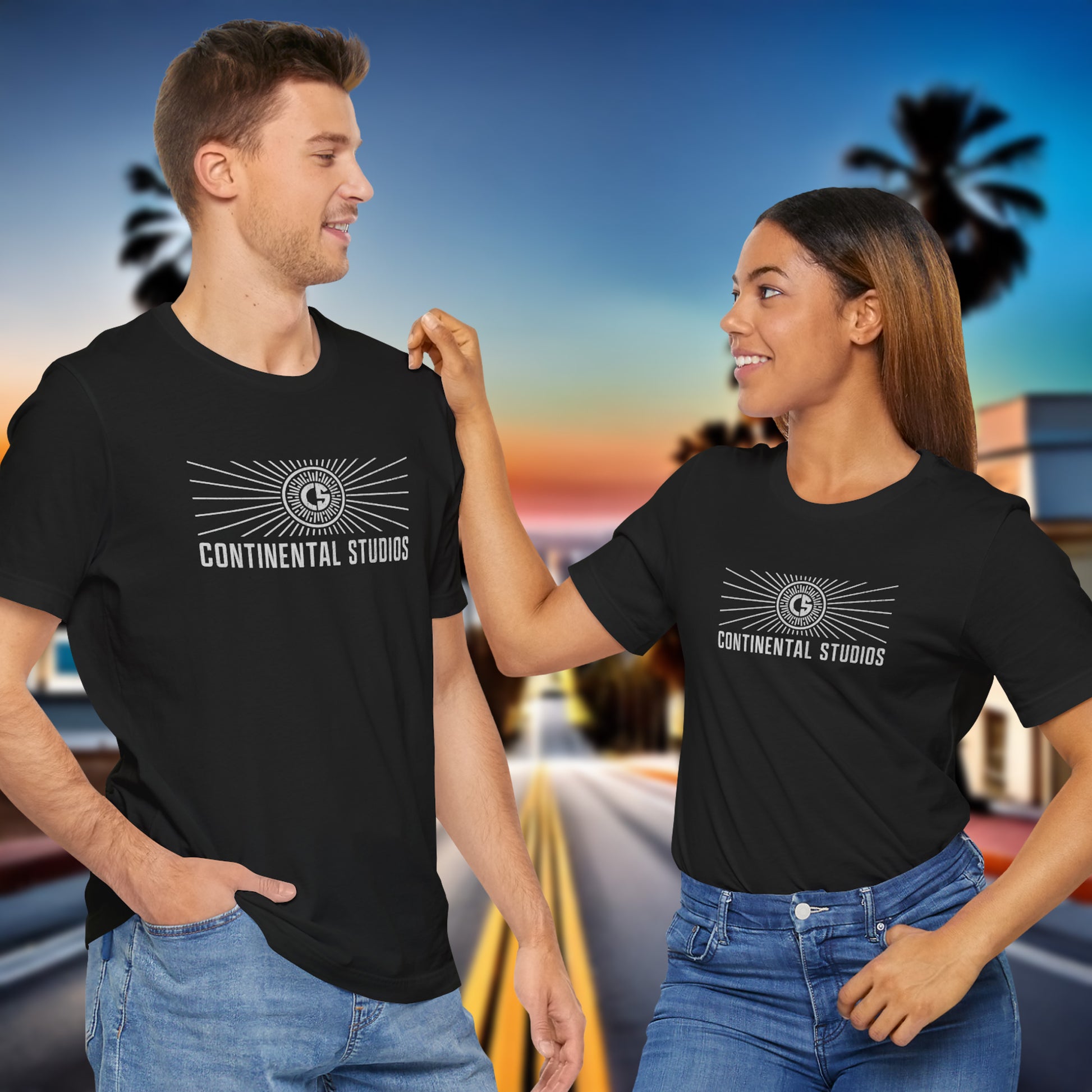 2 models wearing black colored Soft Bella+Canvas 3001 short-sleeve t-shirts featuring the logo graphic of the fictional movie studio Continental Studios inspired by the Apple TV show The Studio in a vintage distressed style, sold by ScriptedBrand.