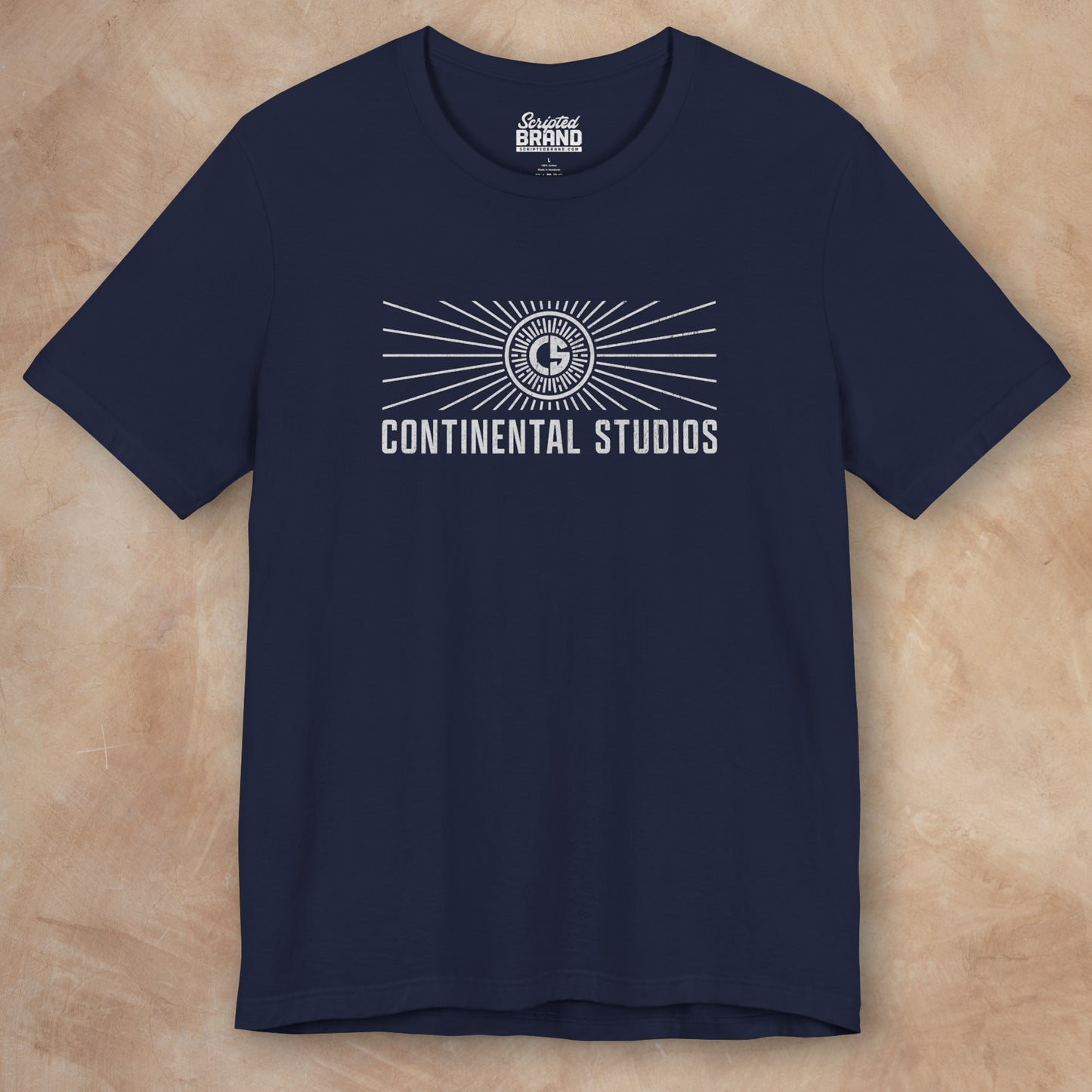 Front view of a navy colored Soft Bella+Canvas 3001 short-sleeve t-shirt featuring the logo graphic of the fictional movie studio Continental Studios inspired by the Apple TV show The Studio in a vintage distressed style, sold by ScriptedBrand.