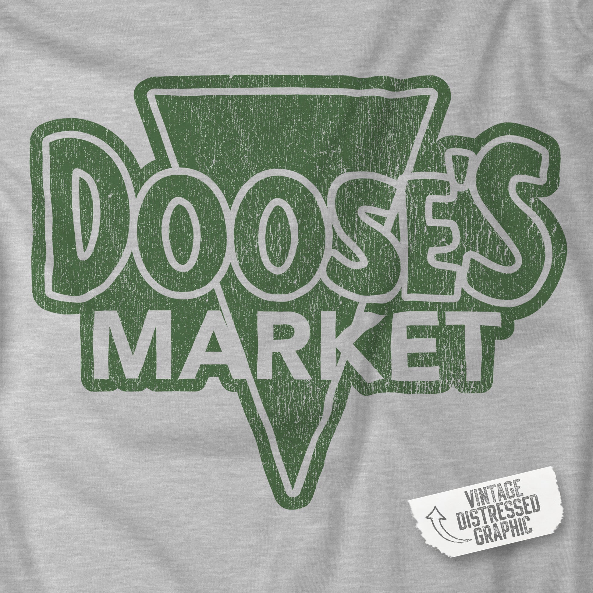 Closeup of Grey Bella+Canvas t-shirt with a vintage-style Doose’s Market logo graphic in green, inspired by Gilmore Girls