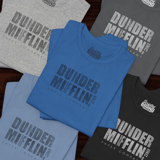 Five folded t-shirts featuring the Dunder Mifflin logo from the TV show The Office in a vintage distressed style.

