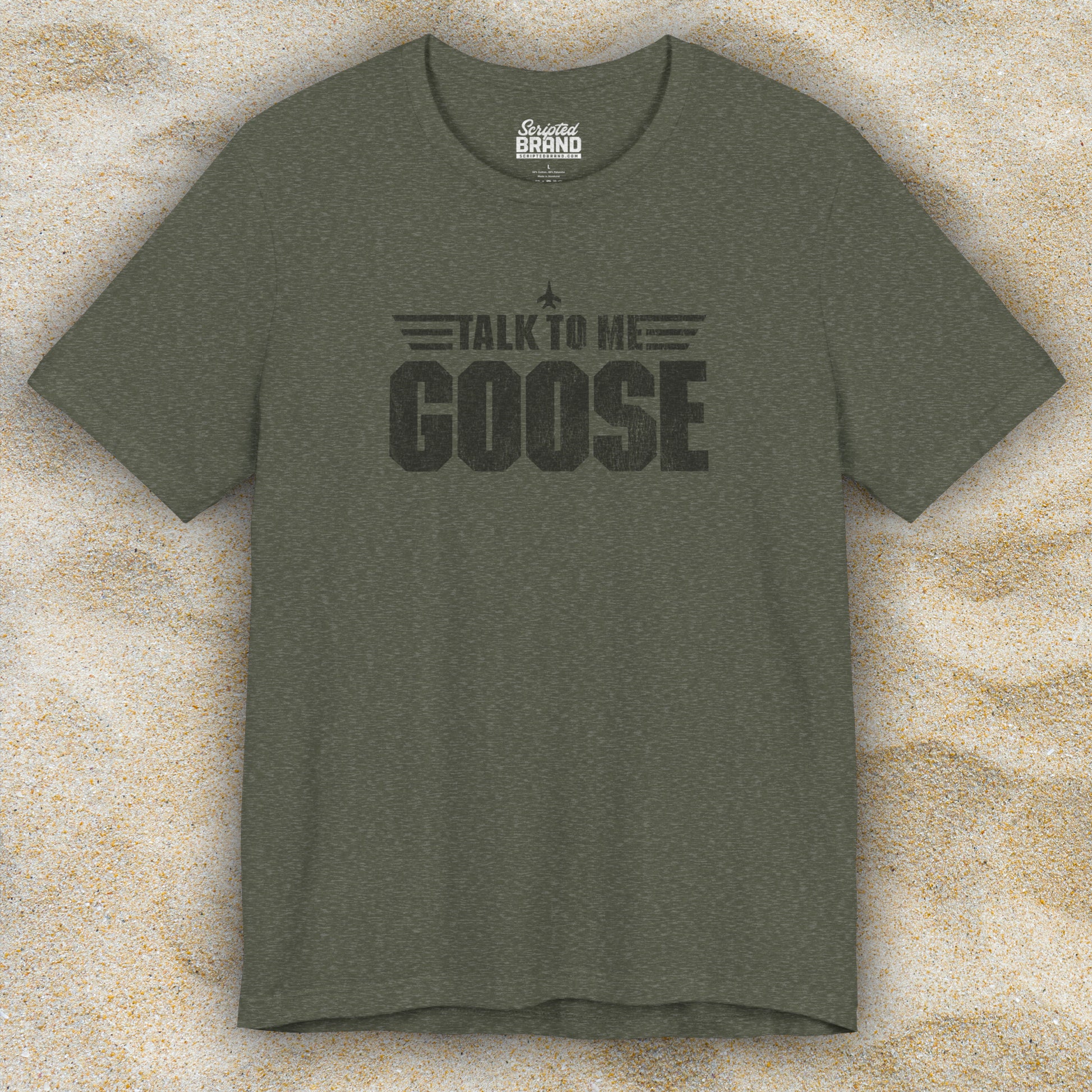 Front view of a heather military green soft unisex Bella+Canvas 3001 short-sleeve t-shirt featuring a graphic designed by ScriptedBrand in a vintage distressed style with the text TALK TO ME GOOSE, inspired by the Movie Top Gun.