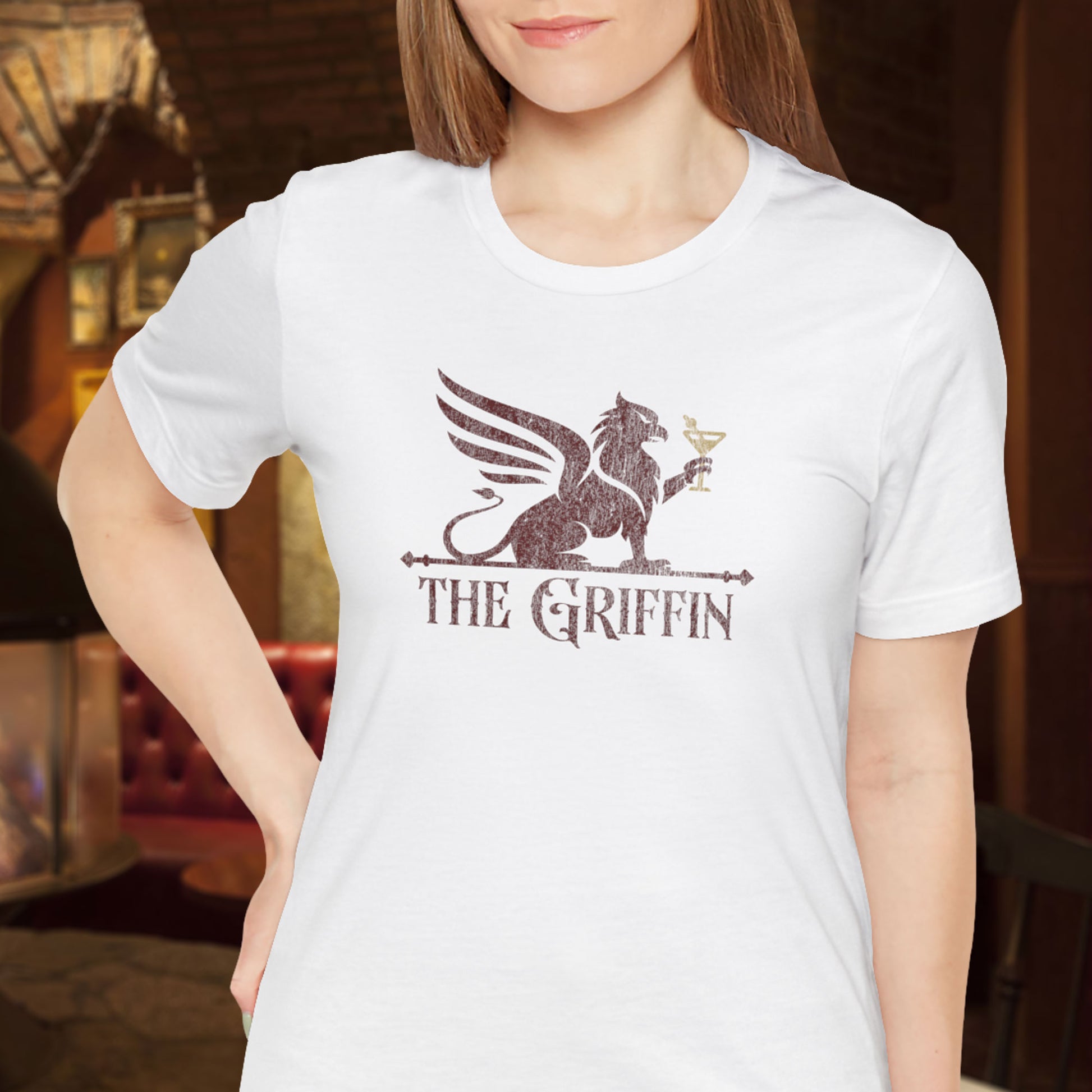 Woman wearing white t-shirt featuring maroon 'The Griffin' Bar logo inspired by the TV show New Girl in a vintage distressed style.