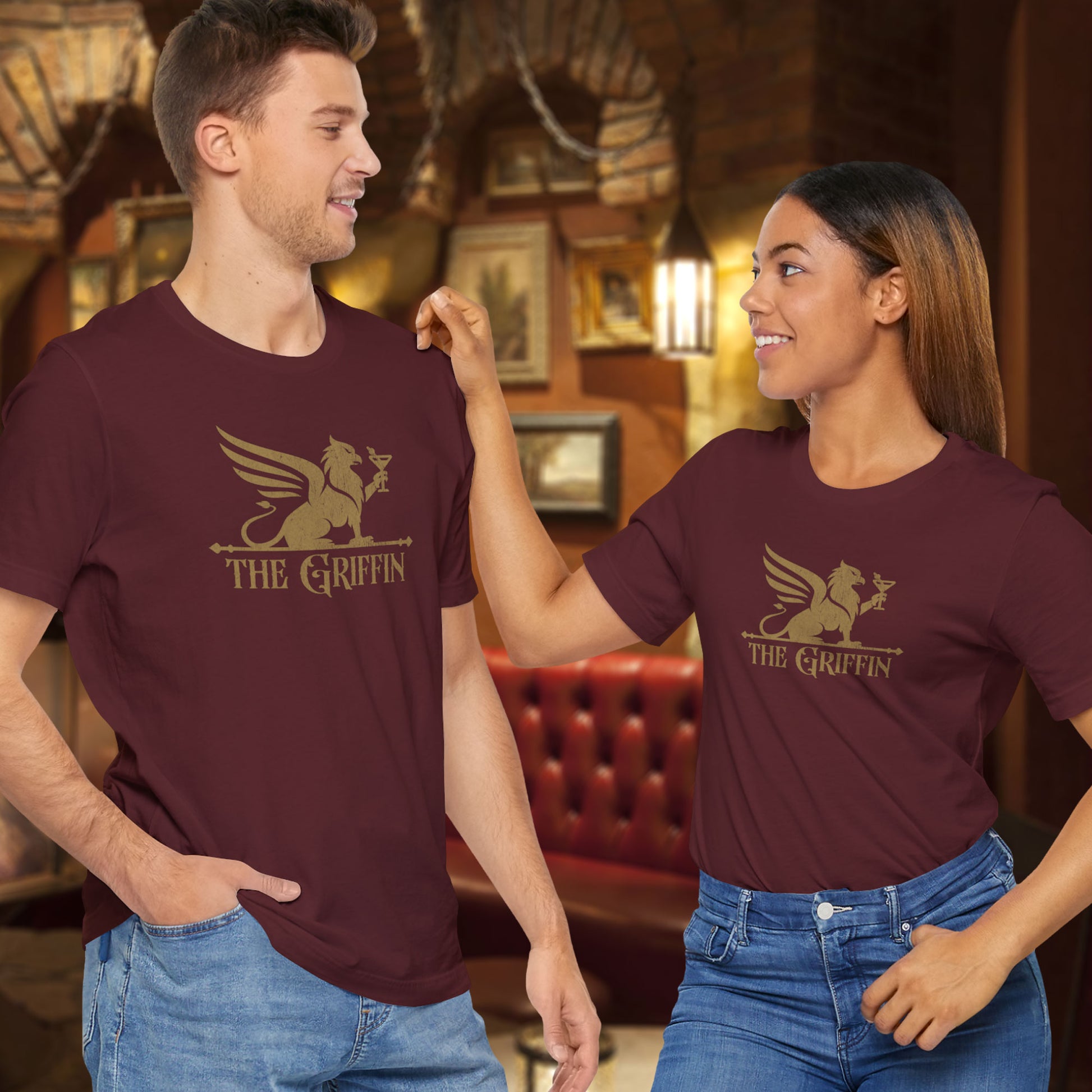 Two people wearing maroon t-shirts featuring gold 'The Griffin' Bar logo inspired by the TV show New Girl in a vintage distressed style.