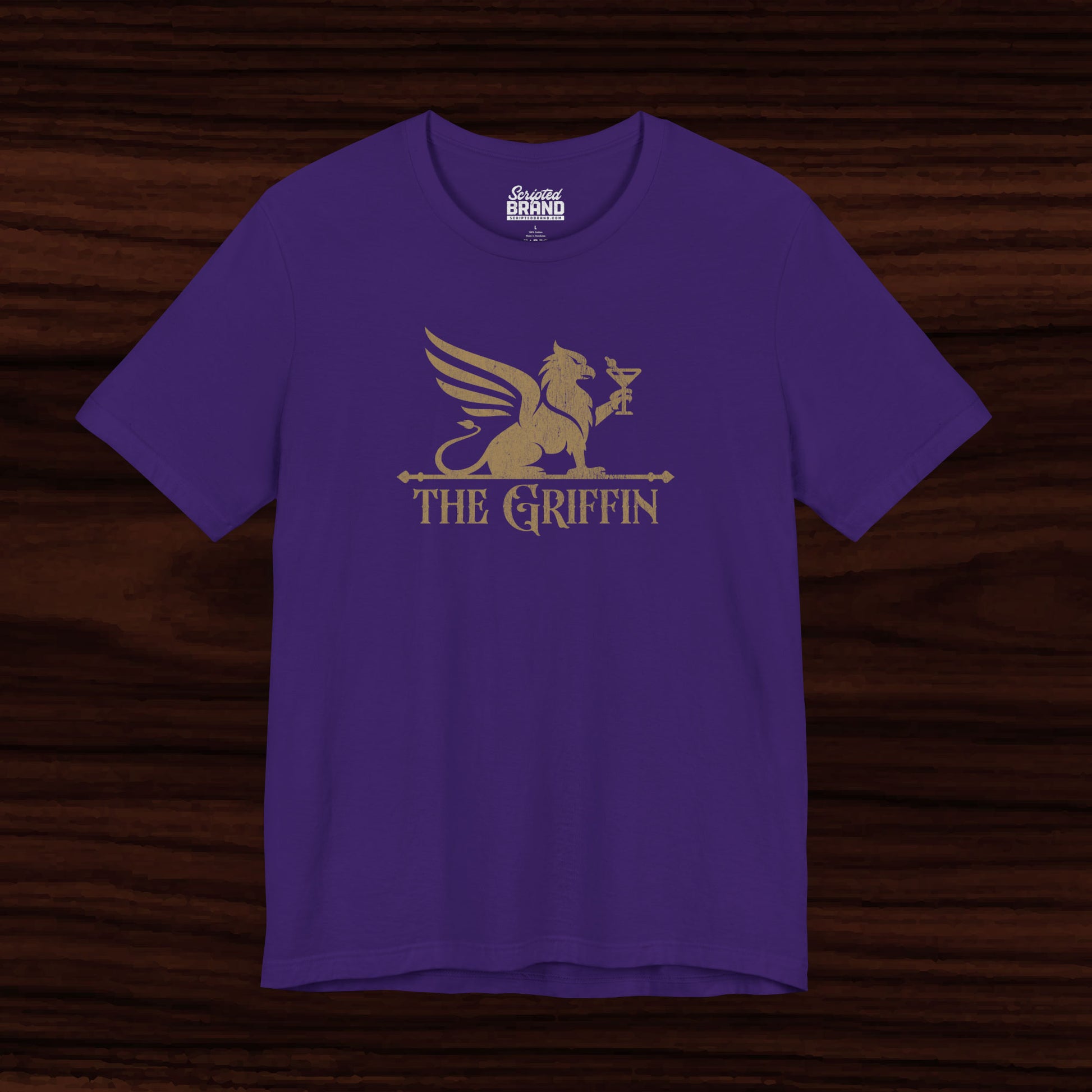 Purple t-shirt featuring gold 'The Griffin' Bar logo inspired by the TV show New Girl in a vintage distressed style.