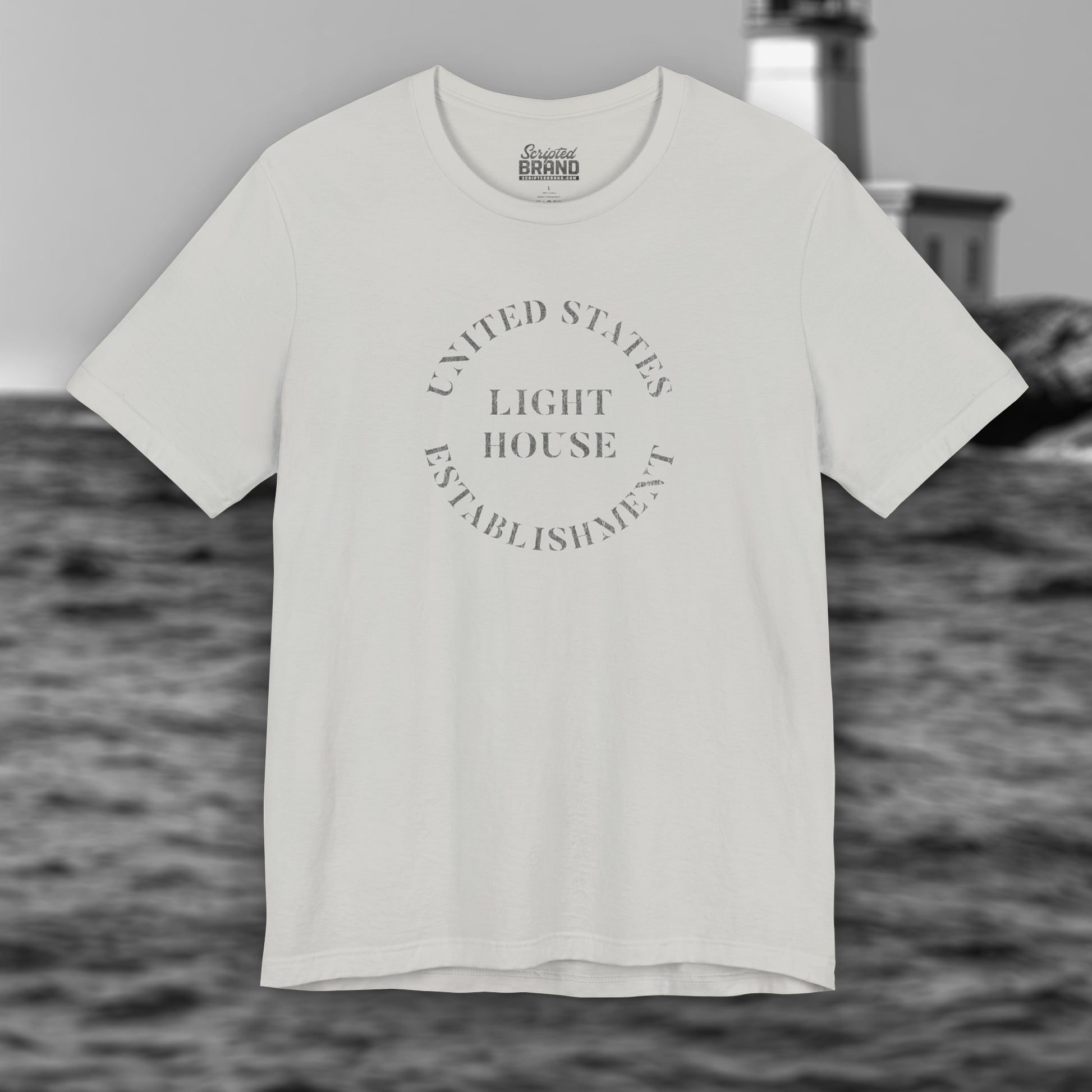 Silver t-shirt featuring the United States Light House Establishment logo graphic worn by Robert Pattinson in the movie The Lighthouse in a vintage distressed style.