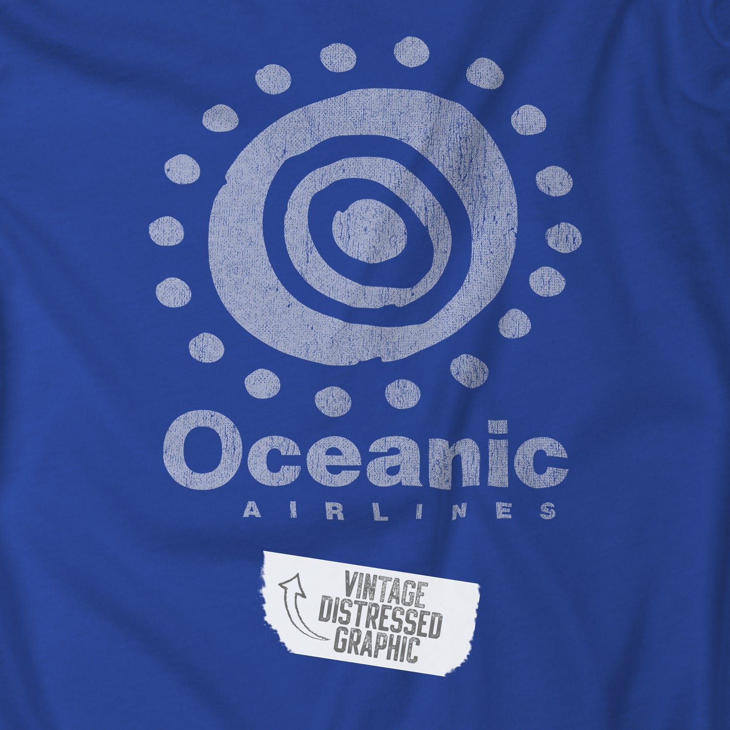 Closeup of Royal blue t-shirt featuring the Oceanic Airlines logo graphic from the TV show LOST in a vintage distressed style.