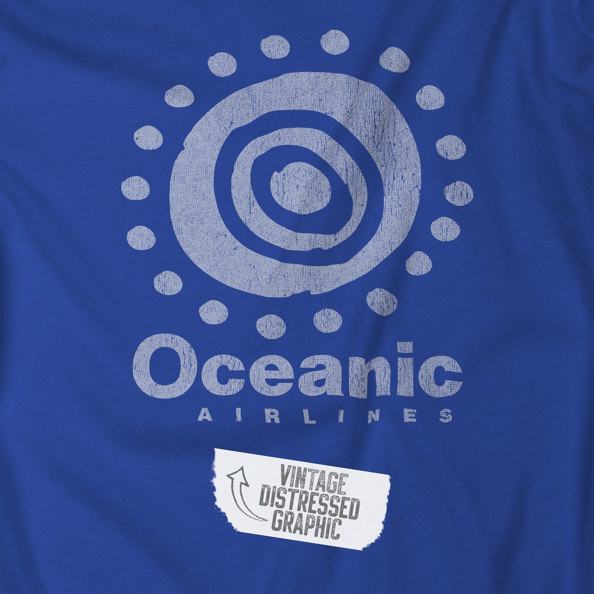 Closeup of Royal blue t-shirt featuring the Oceanic Airlines logo graphic from the TV show LOST in a vintage distressed style.