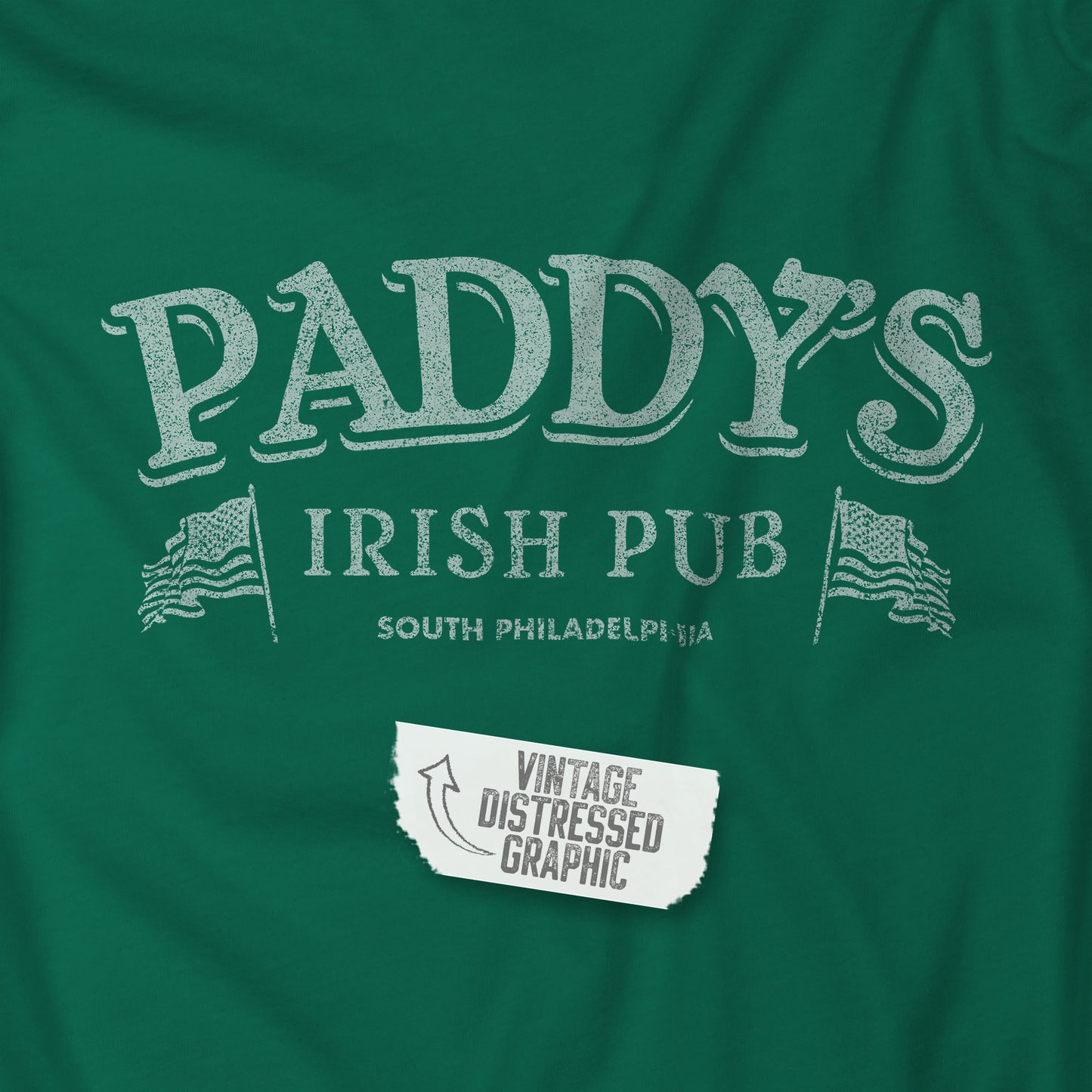 Closeup view of a kelly green colored soft Bella+Canvas 3001 short-sleeve t-shirt tee featuring the Paddy's Pub logo from the TV Show It's Always Sunny in Philadelphia, in a vintage distressed style, sold by ScriptedBrand.