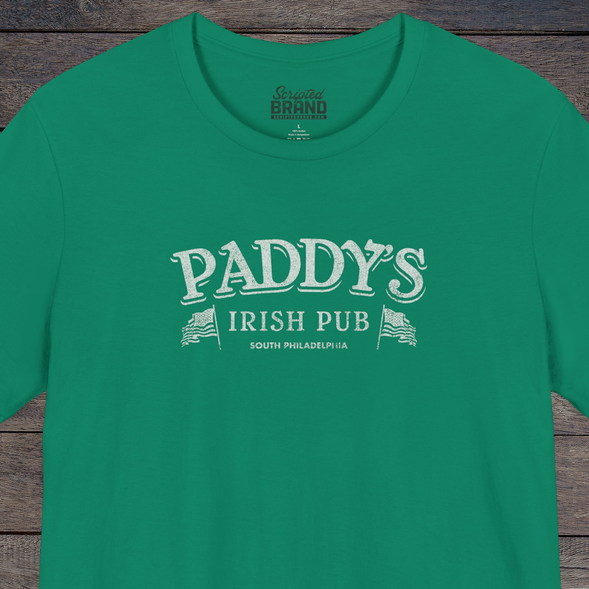 Front view of a kelly green colored soft Bella+Canvas 3001 short-sleeve t-shirt tee featuring the Paddy's Pub logo from the TV Show It's Always Sunny in Philadelphia, in a vintage distressed style, sold by ScriptedBrand.
